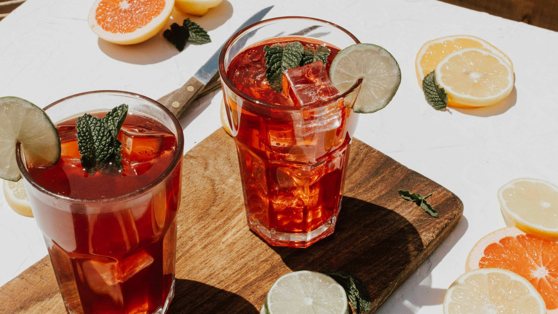 two clear drinking glasses with filled red liquid