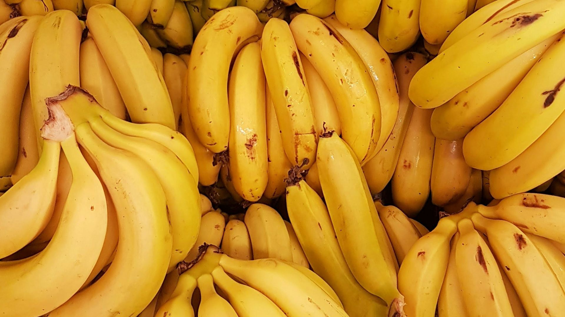 yellow banana fruit on brown wooden table