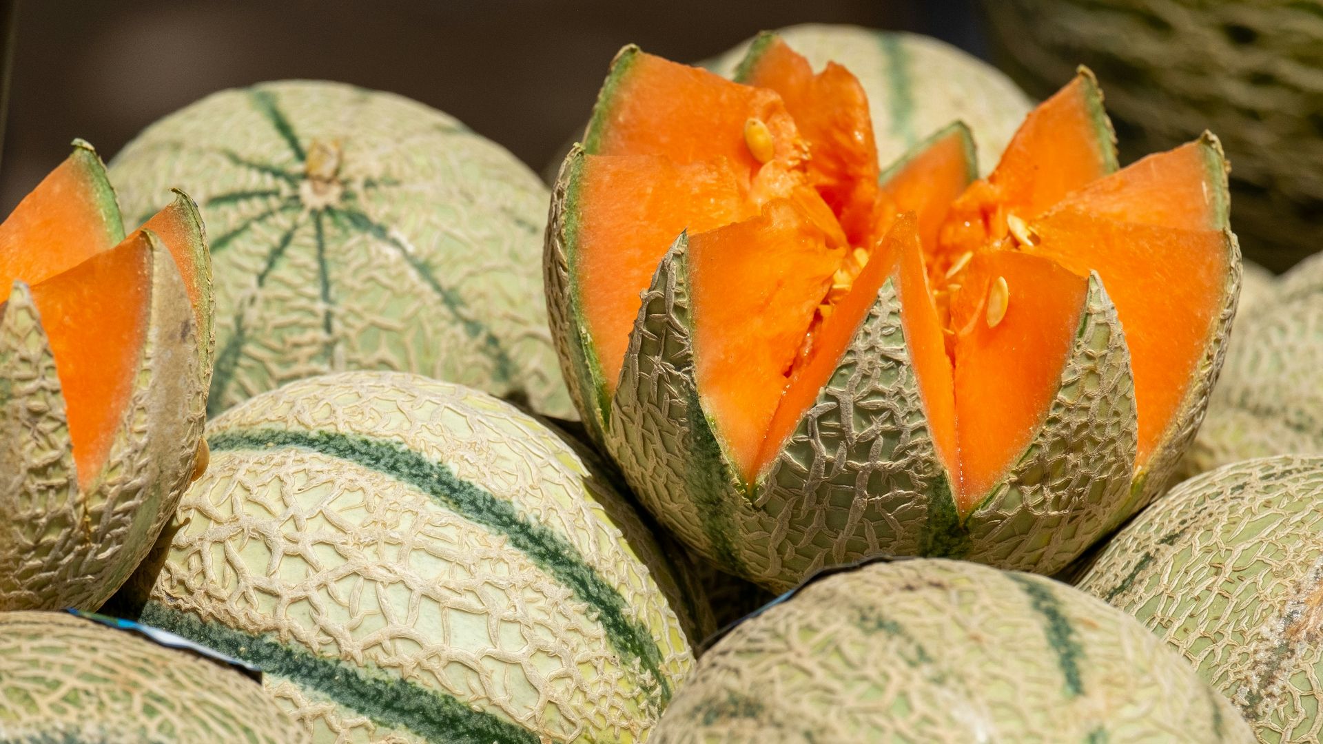 a group of melons with one cut in half