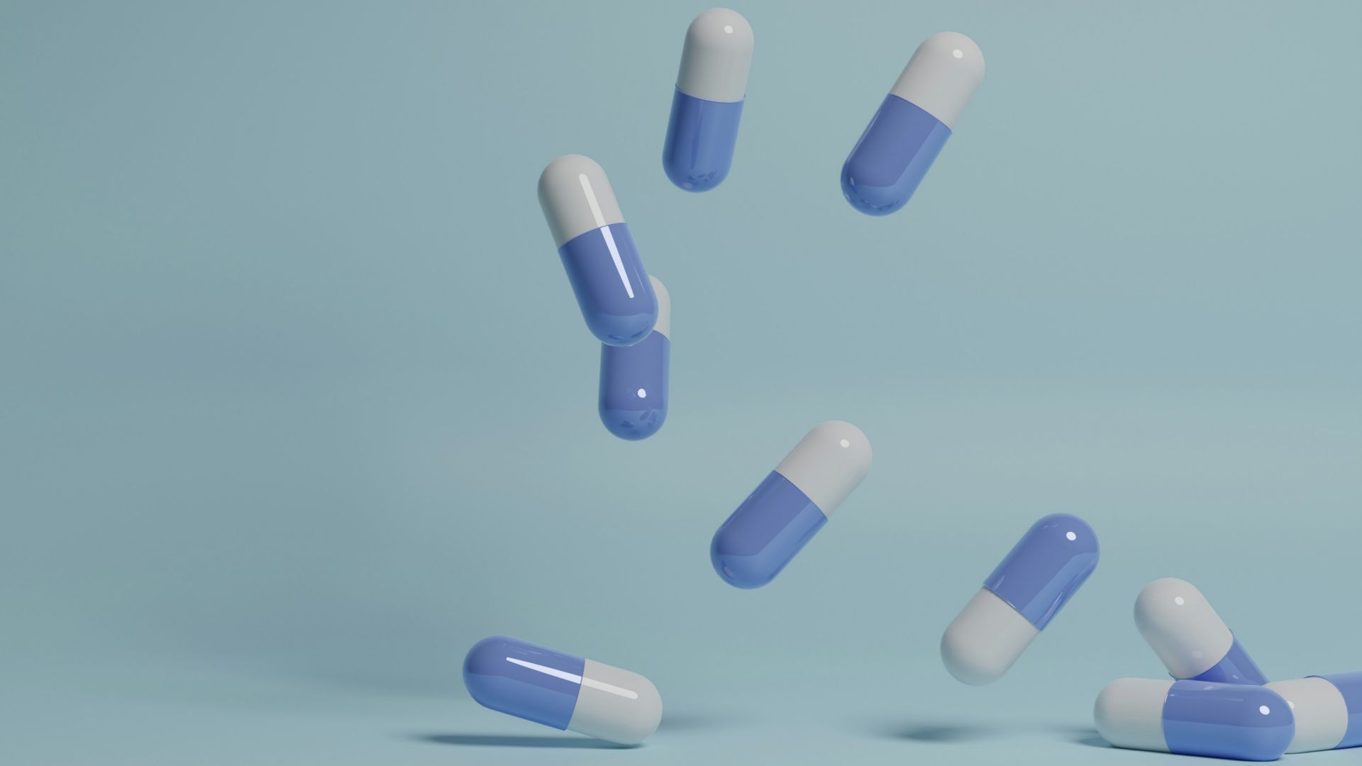 a group of pills falling into the air