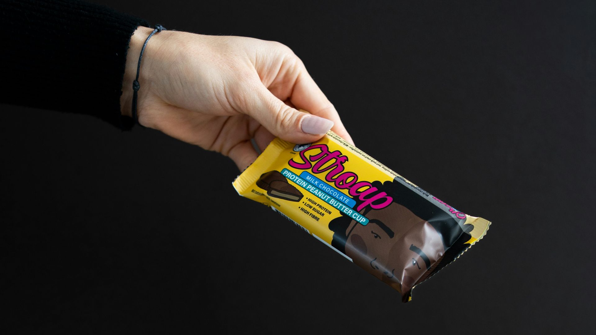 a person holding a package of chocolate in their hand