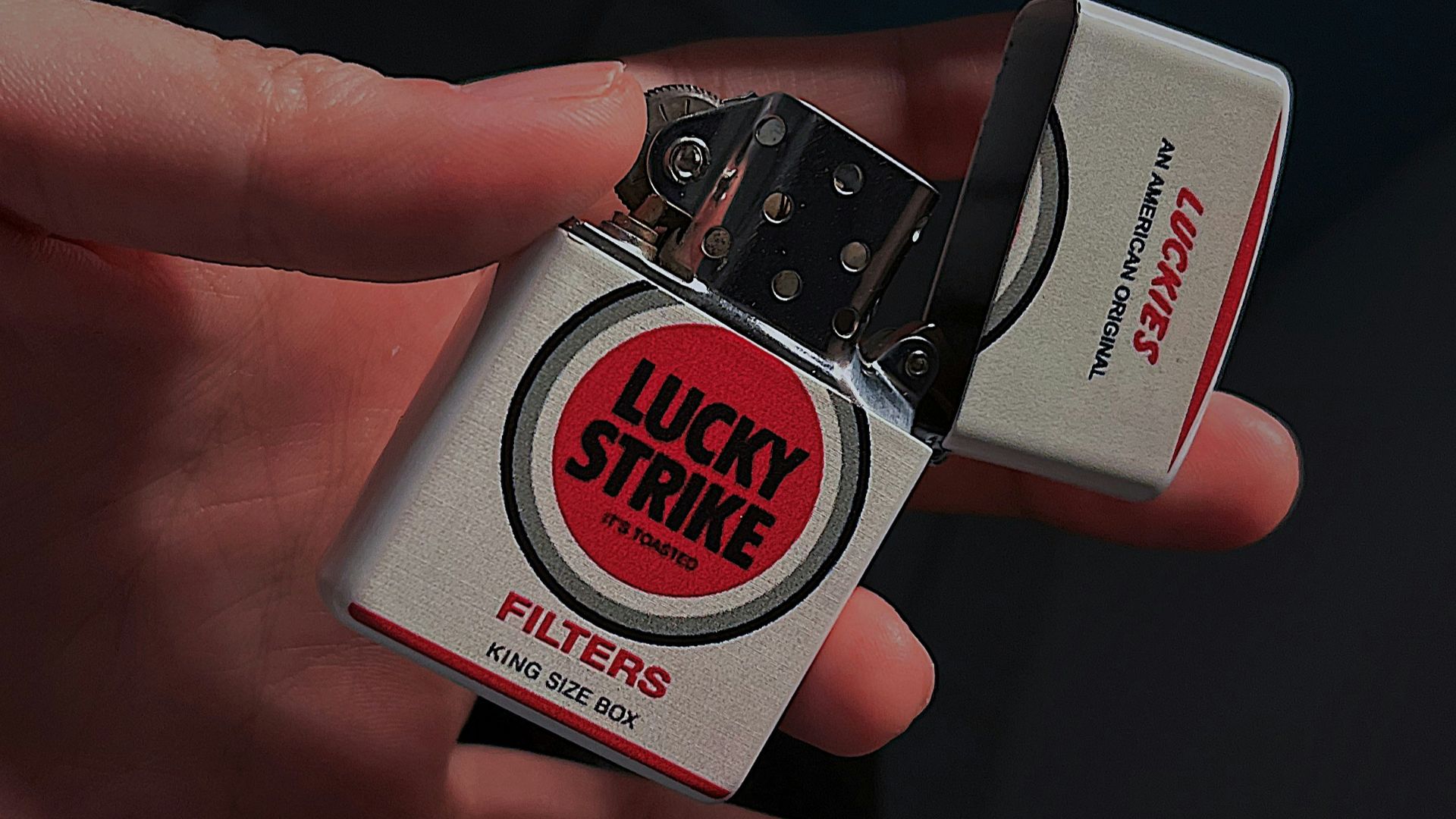 a person holding a lighter in their hand