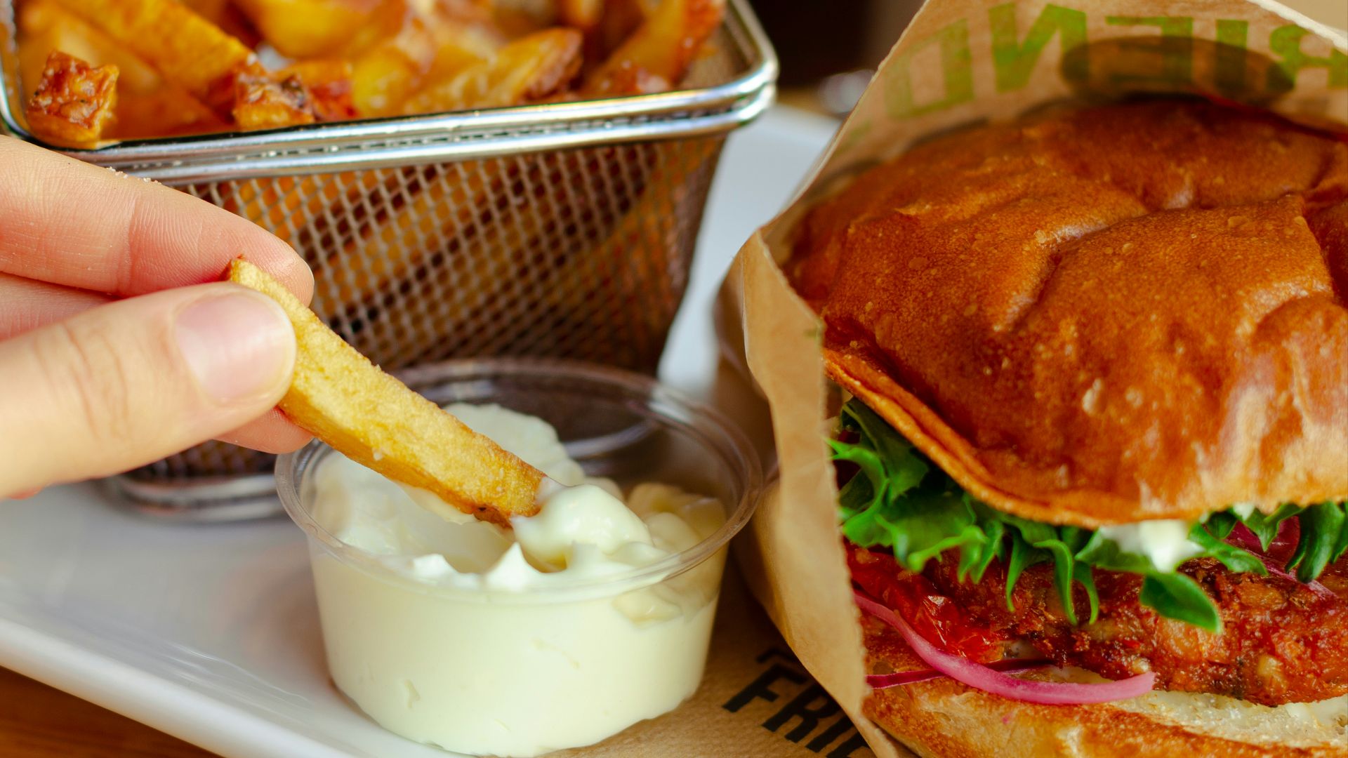 burger with cheese and vegetable on stainless steel tray
