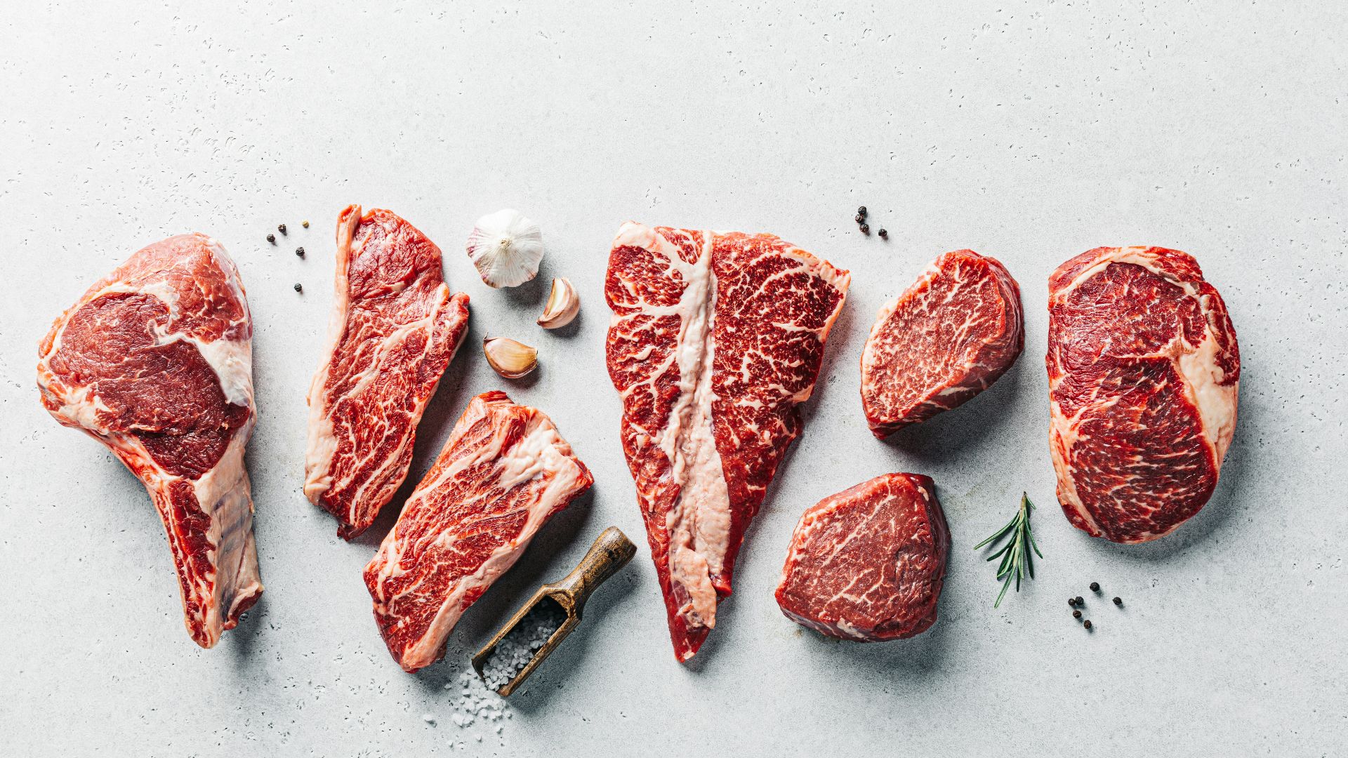 a group of raw meats on a table