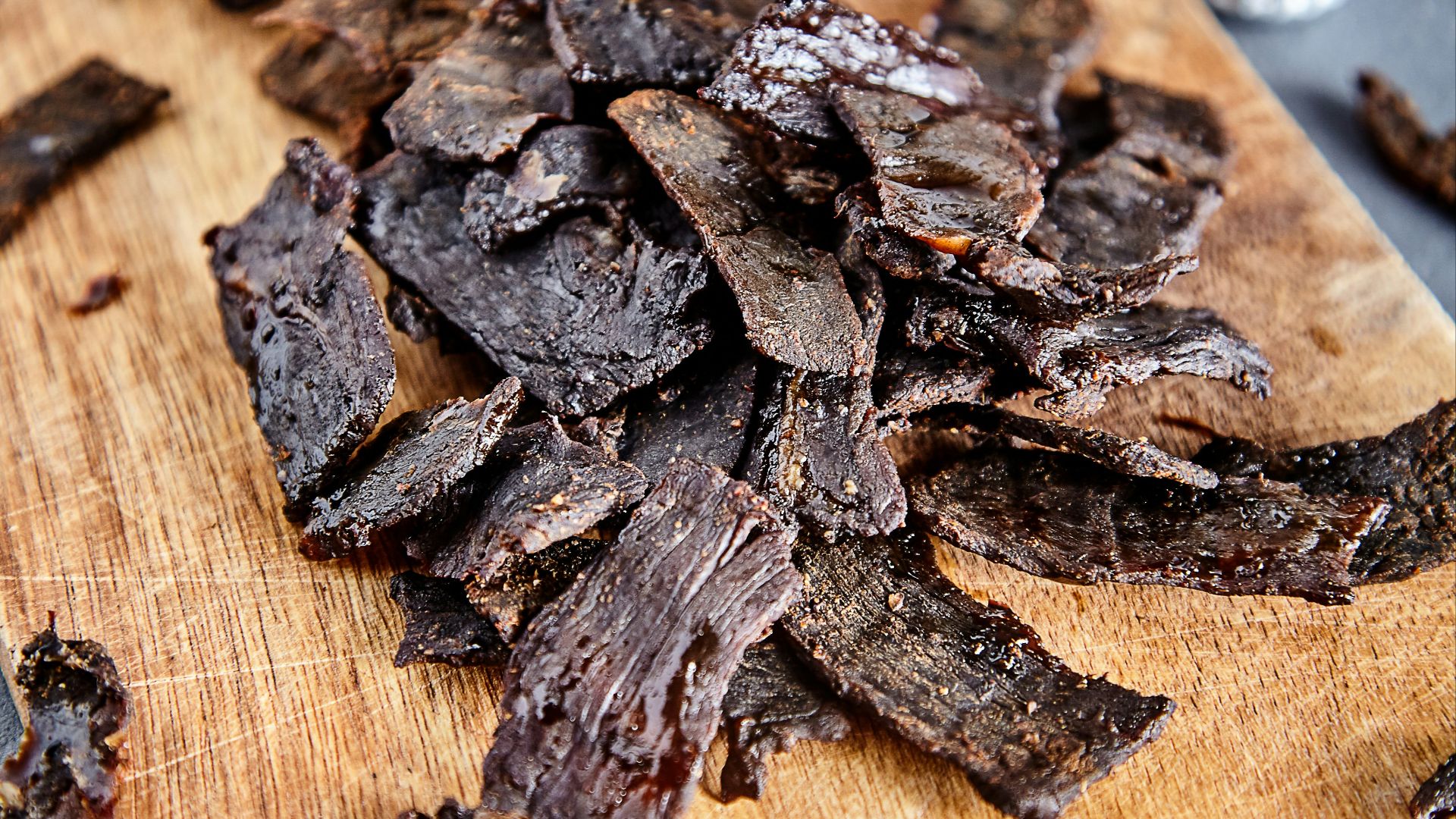 a wood cutting board with brown objects on it