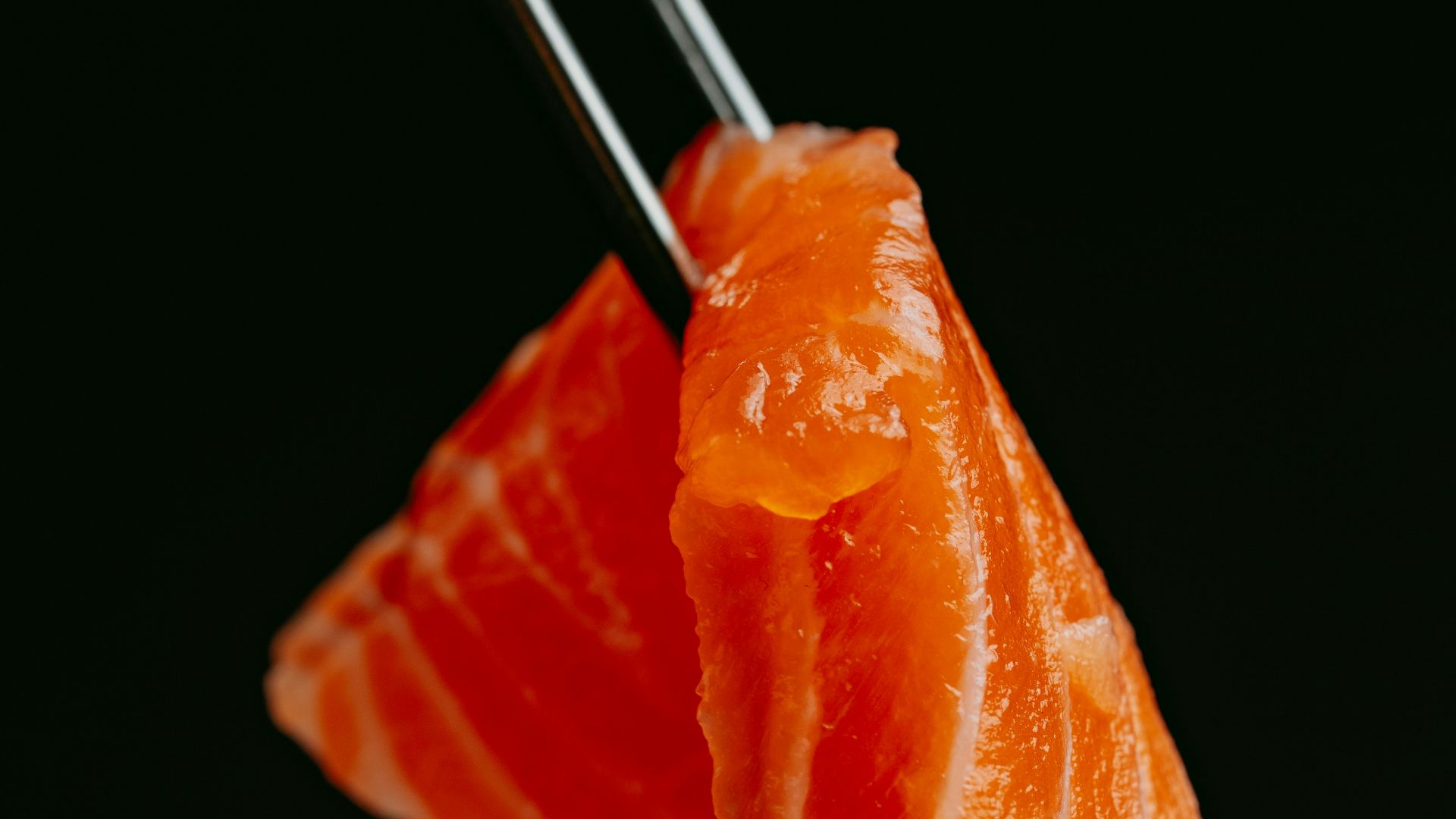 a piece of sushi with chopsticks sticking out of it