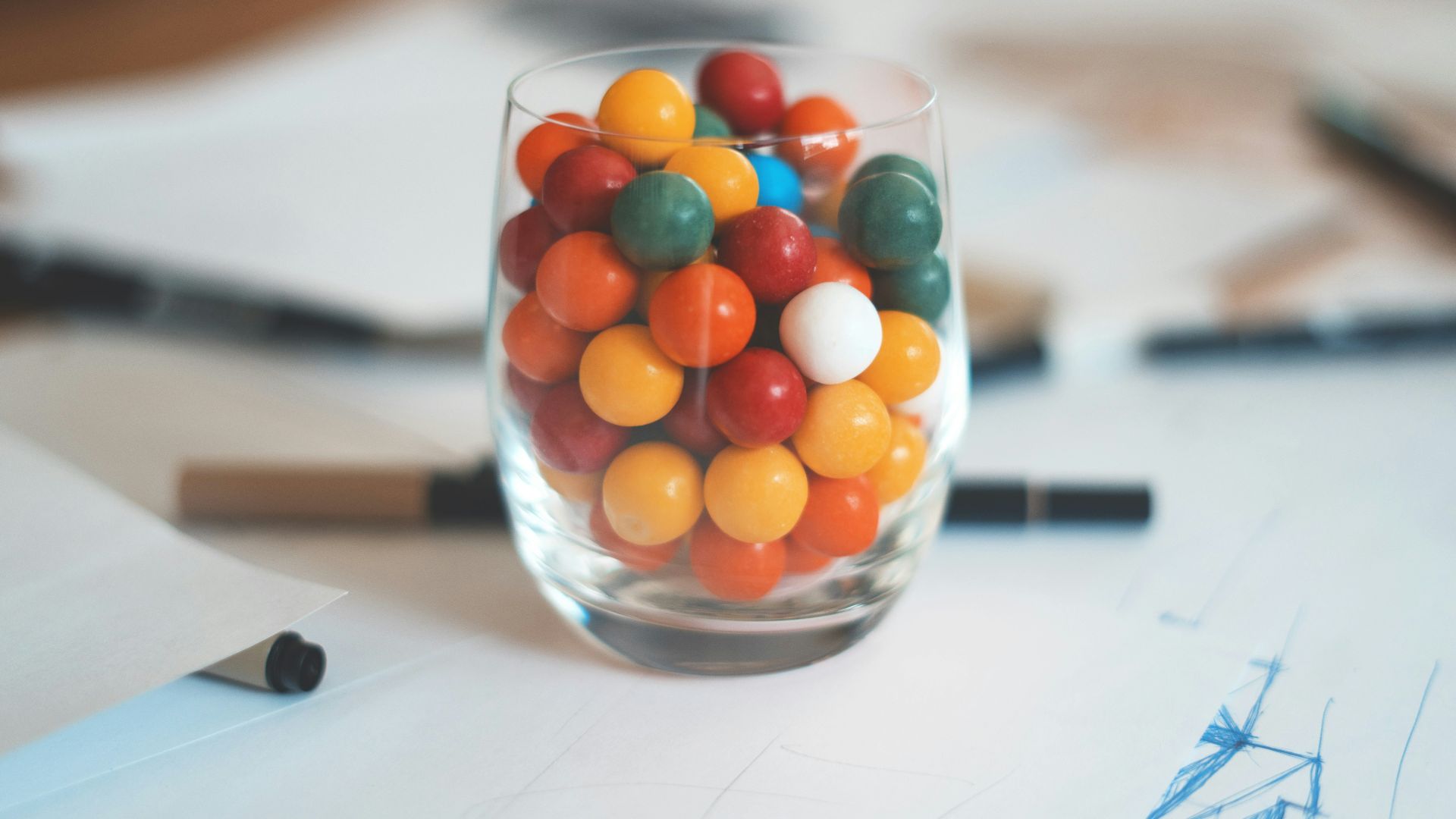 multicolored balls in clear shot glass