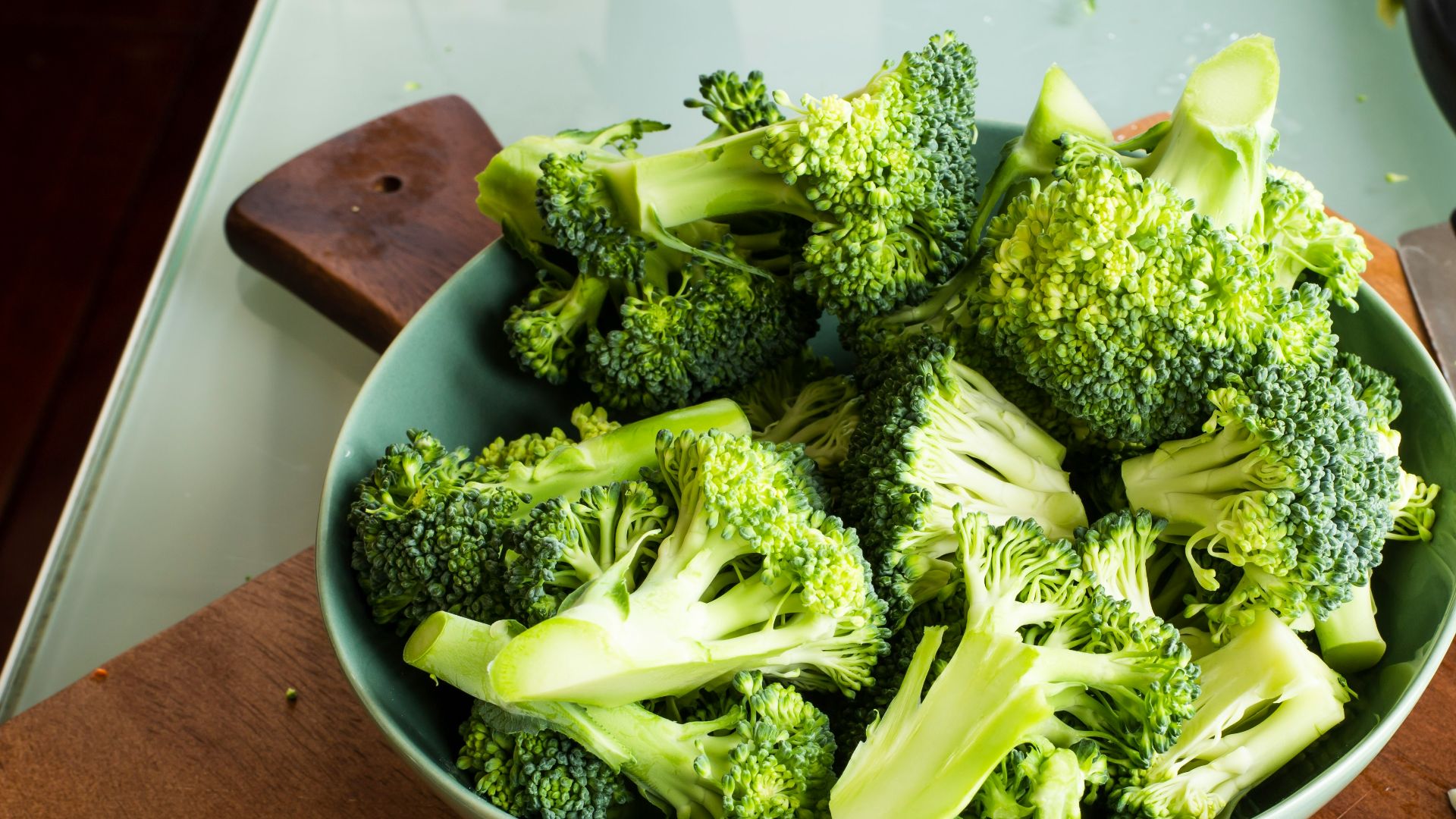 green broccoli on brown wooden chopping board