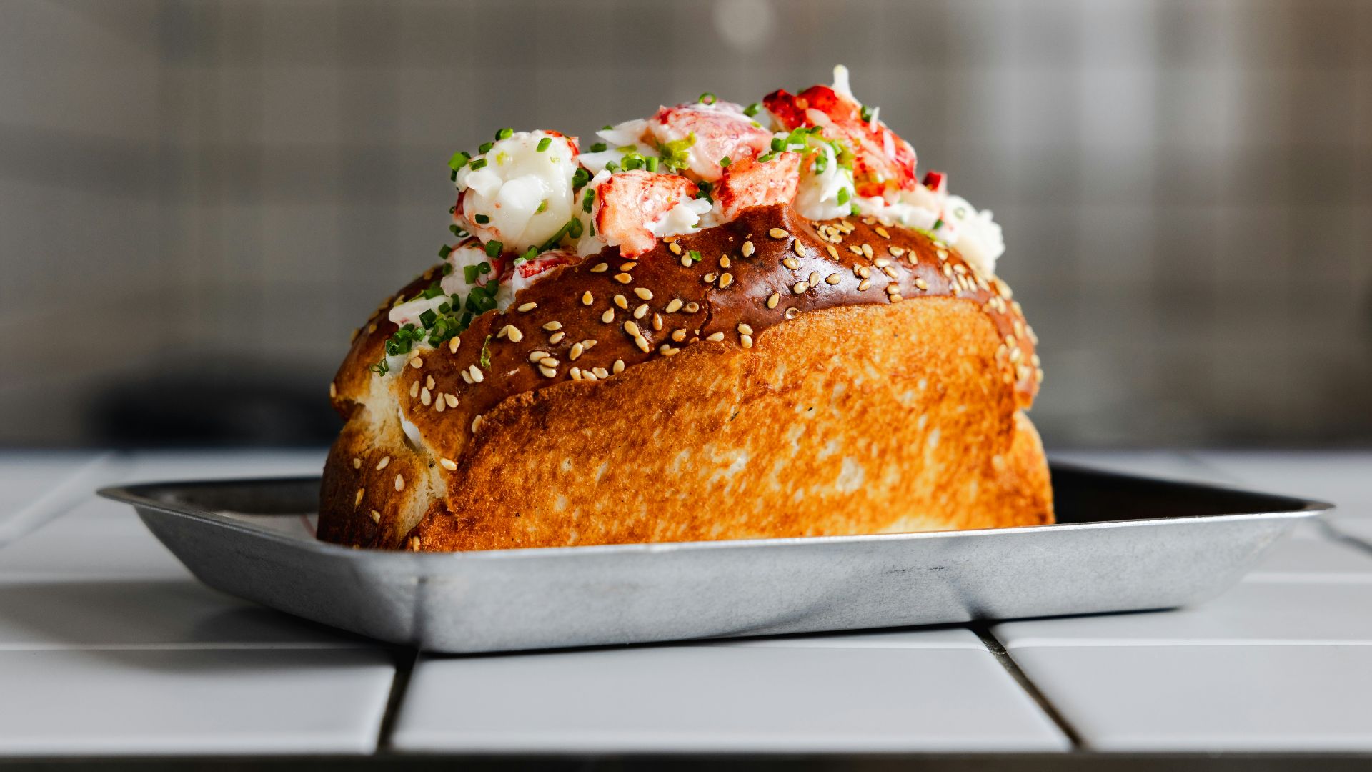A delicious lobster roll on a plate.