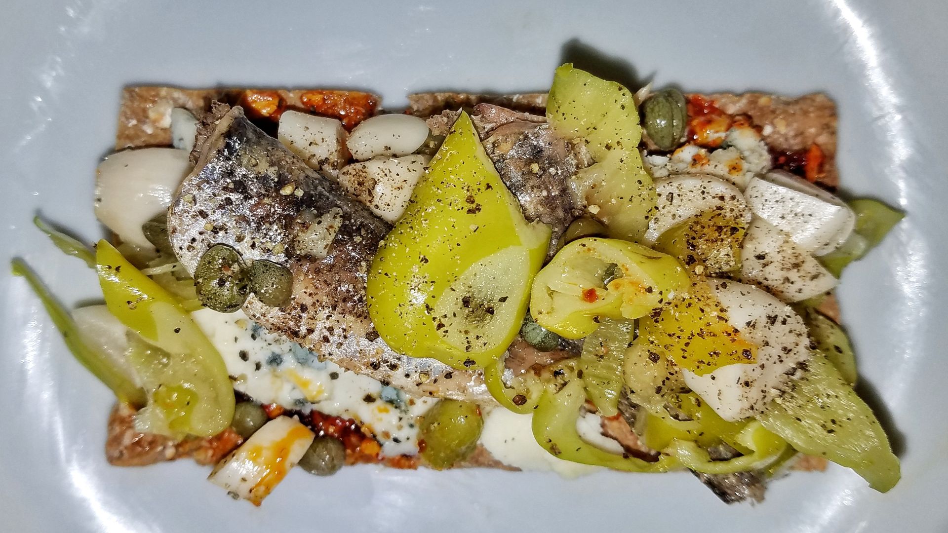 File:Smørrebrød homage 02 - anchovies, blue cheese, pickled garlic, peperoncini, capers, pepper, S&B umami paste on Wasa rye crisp - Massachusetts.jpg