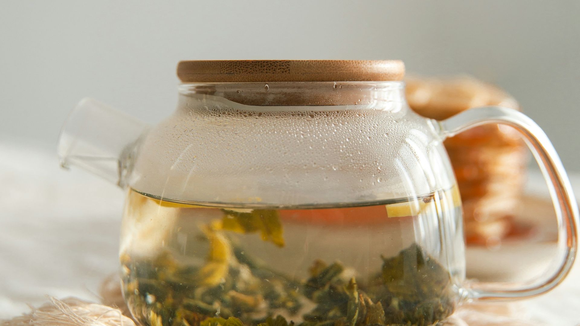 clear glass jar on white textile