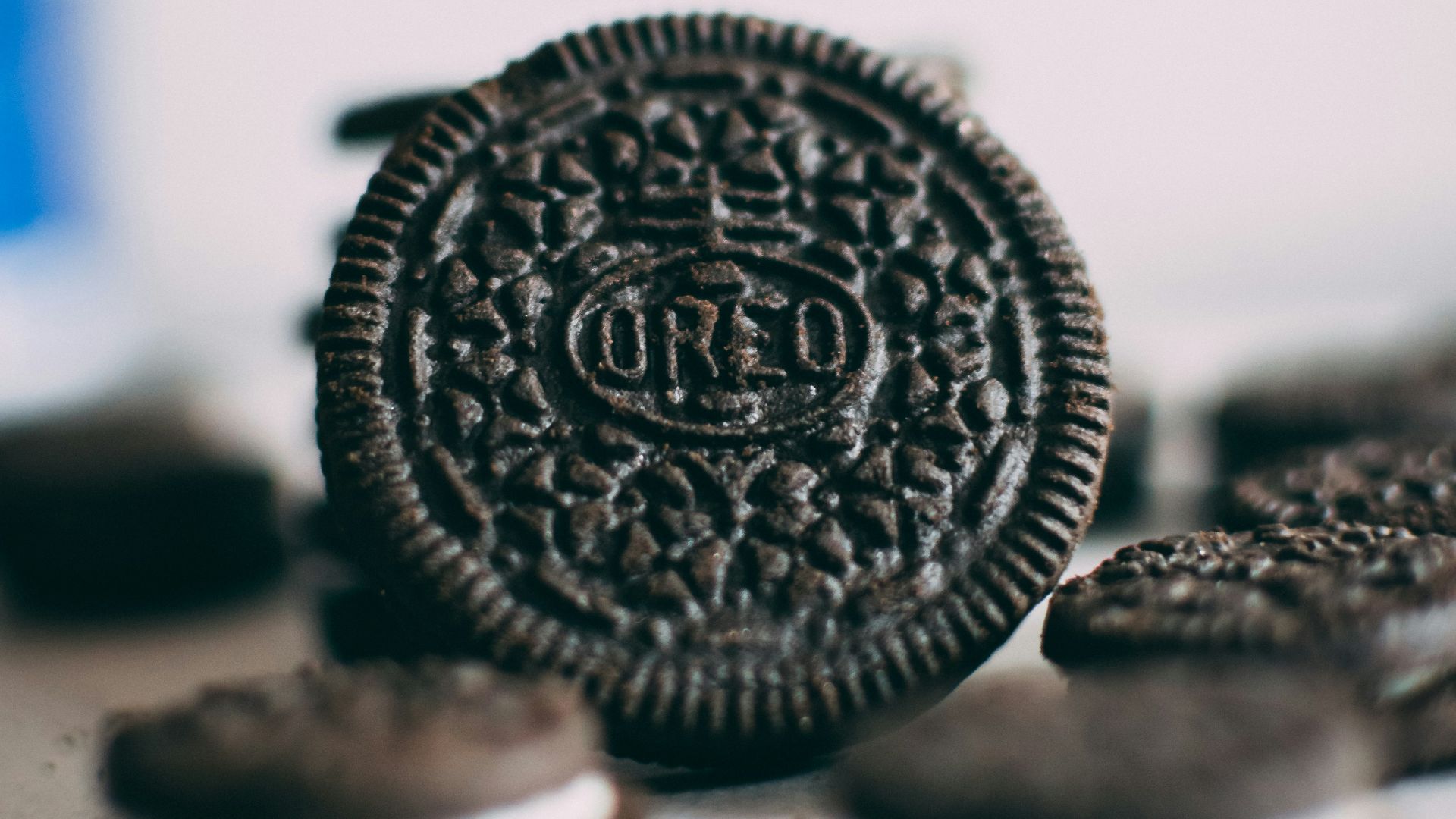 silver round coin on white surface