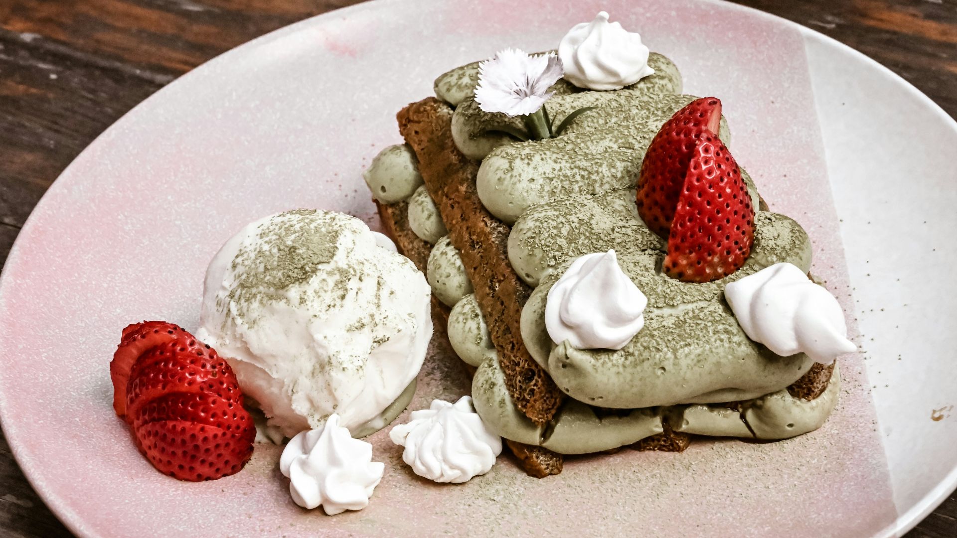 white ice cream with strawberry on white ceramic plate