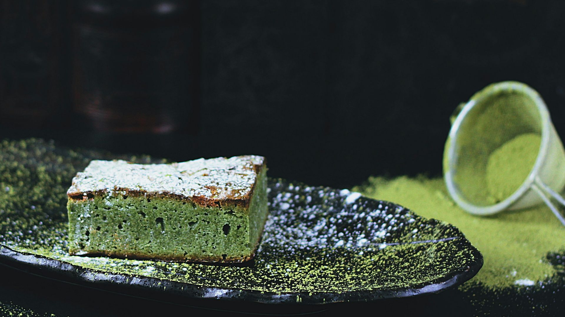 green and brown sponge cake on black oval plate