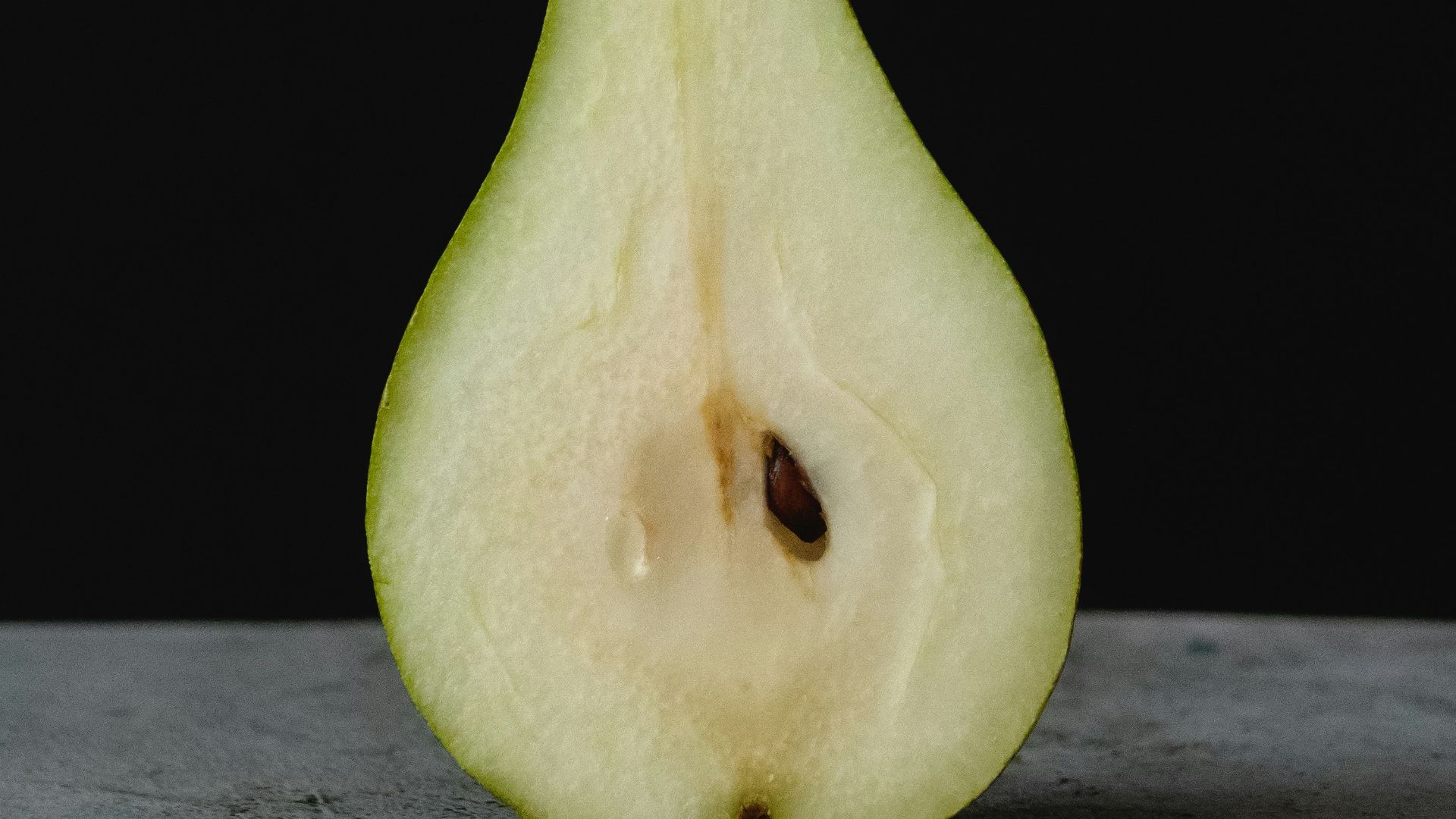 green fruit on gray wooden table
