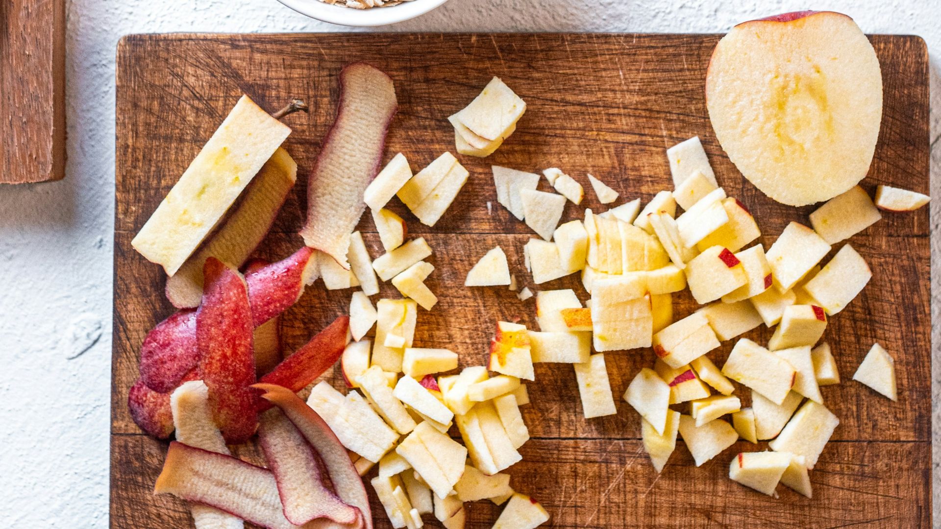 sliced cheese on brown wooden chopping board beside stainless steel knife