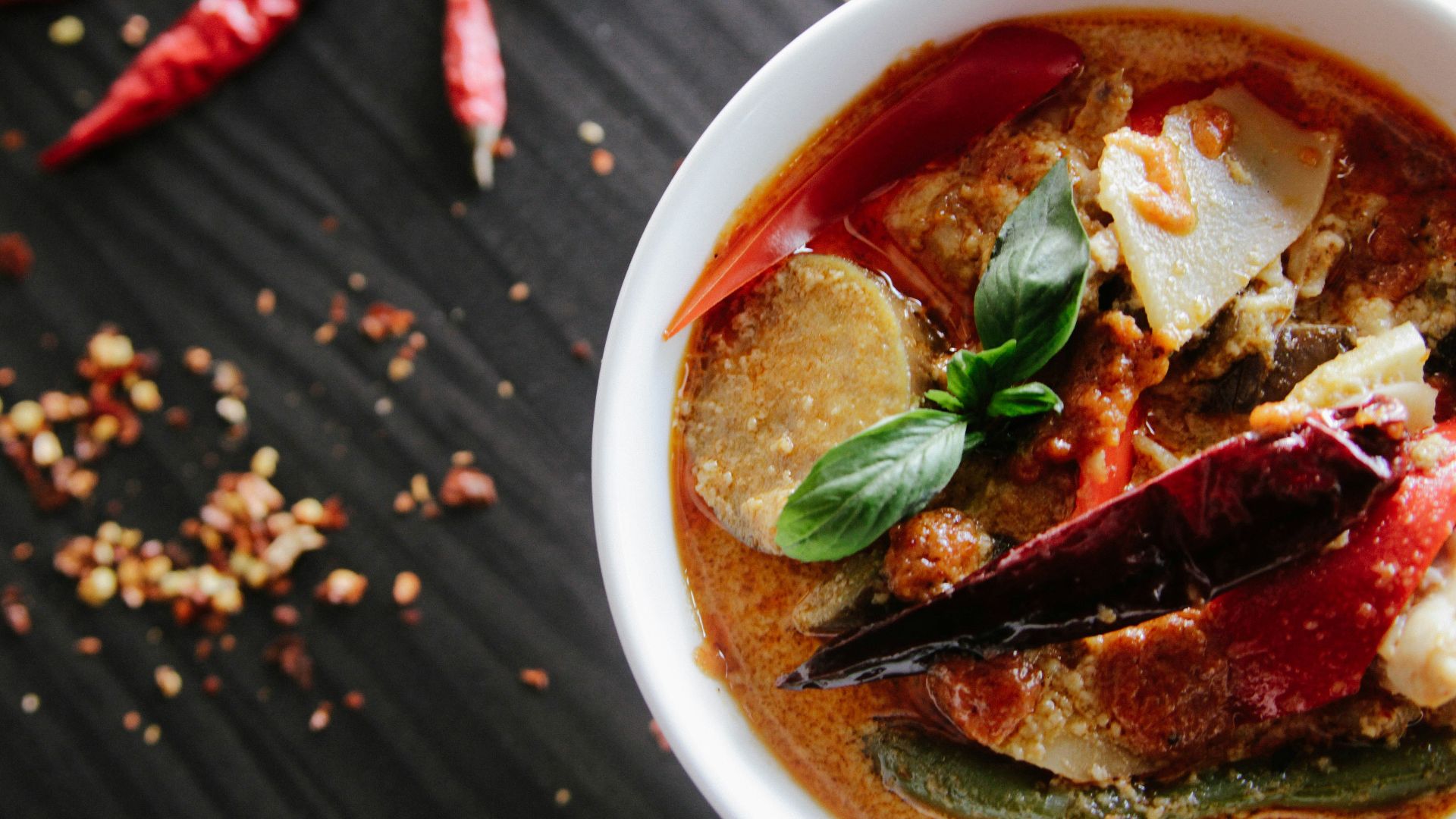 flat-lay photography of vegetable soup on white ceramic cup