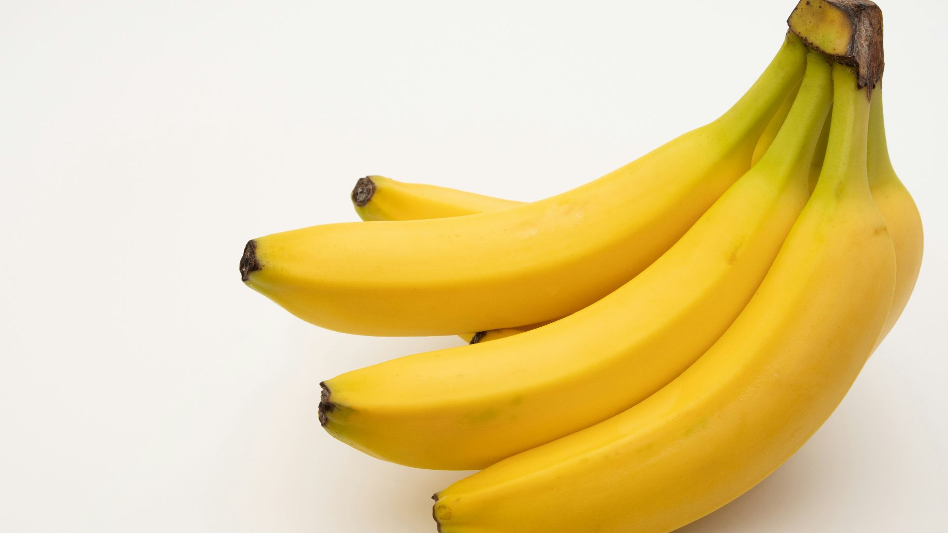 a bunch of bananas sitting on top of a white table