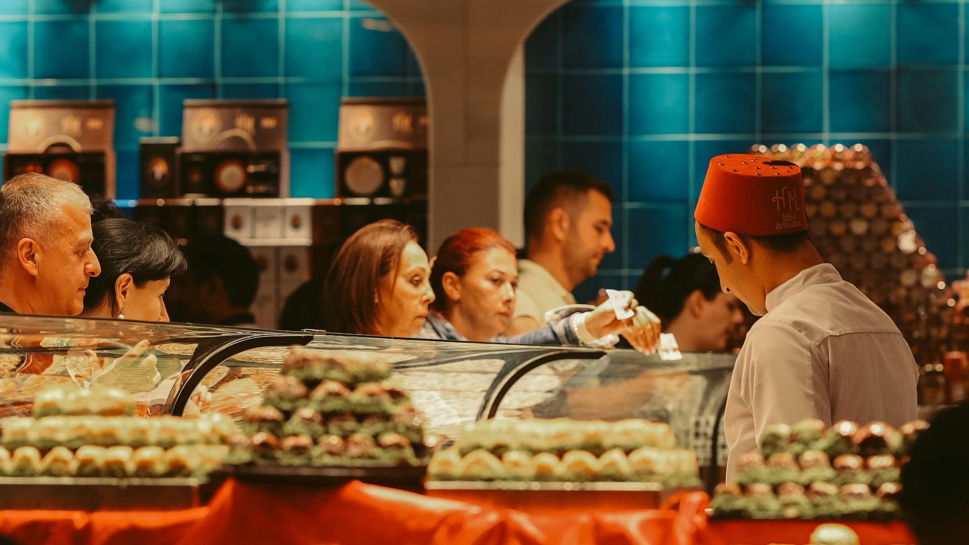 a group of people sitting at a table in a restaurant