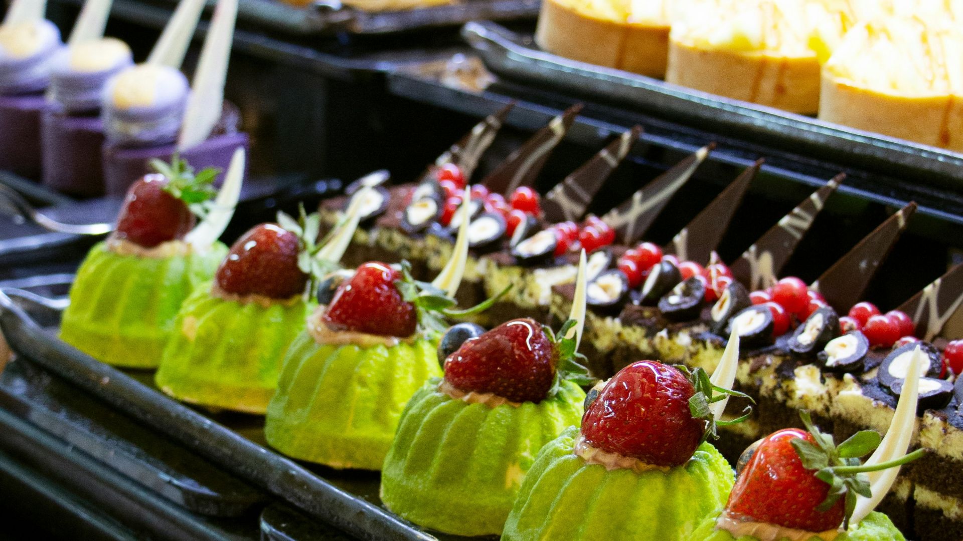 a variety of desserts on display in a buffet
