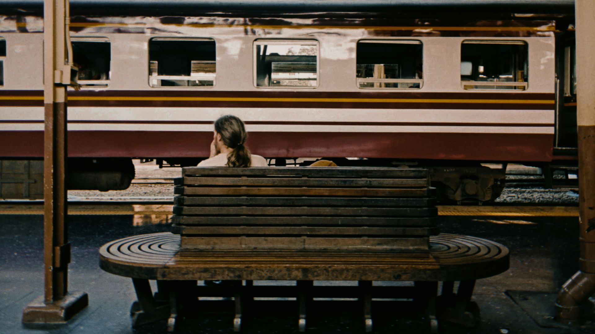 woman in black jacket sitting on bench