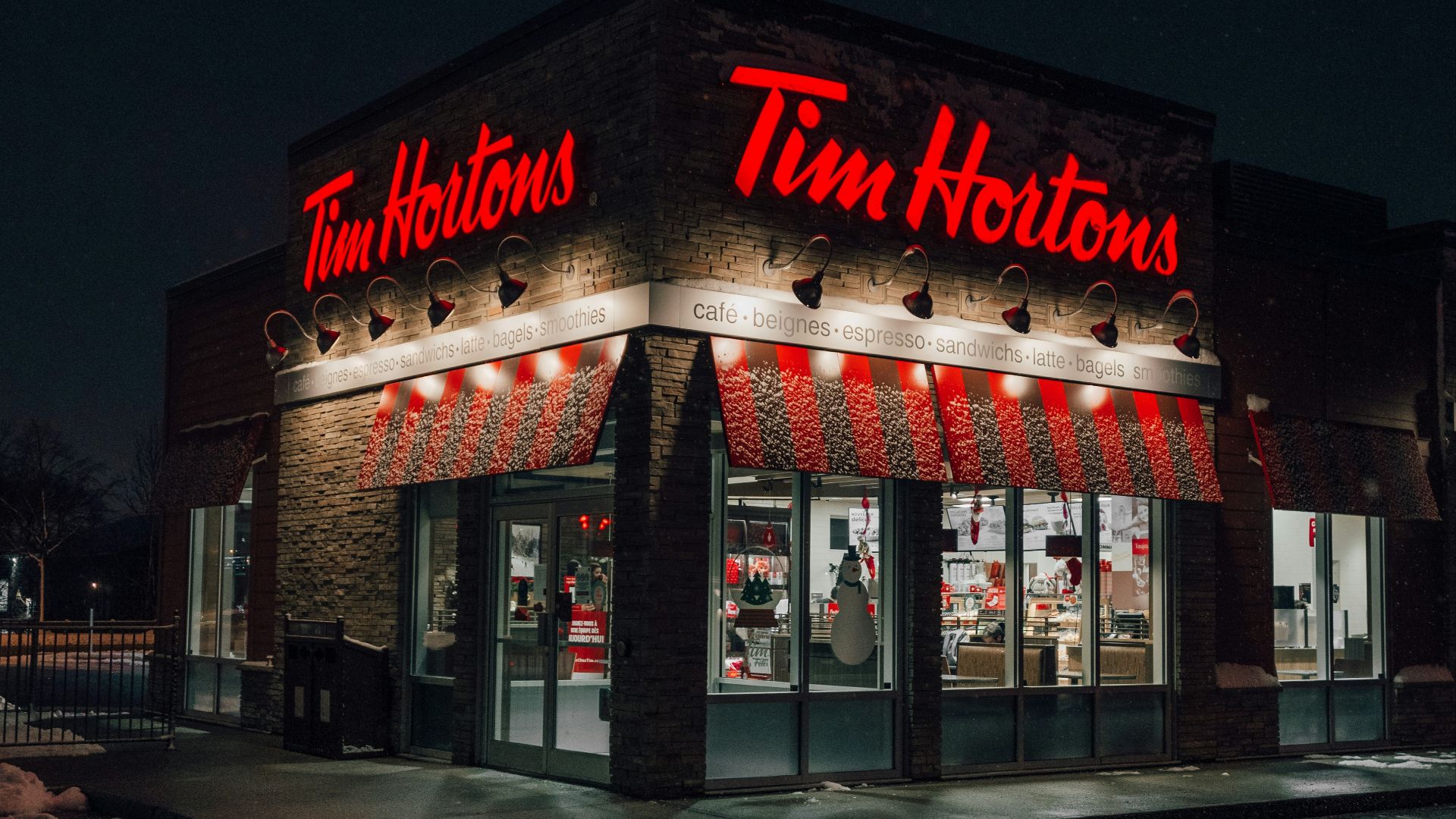 a tim hortons store lit up at night