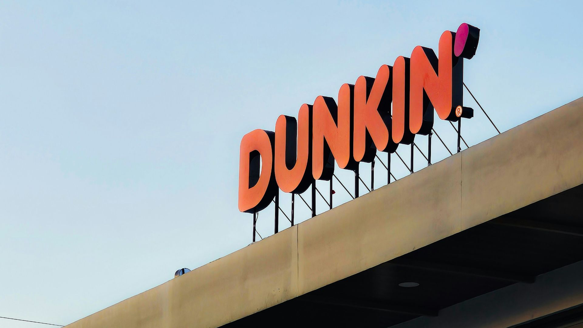 a dunkin'donuts sign on top of a building