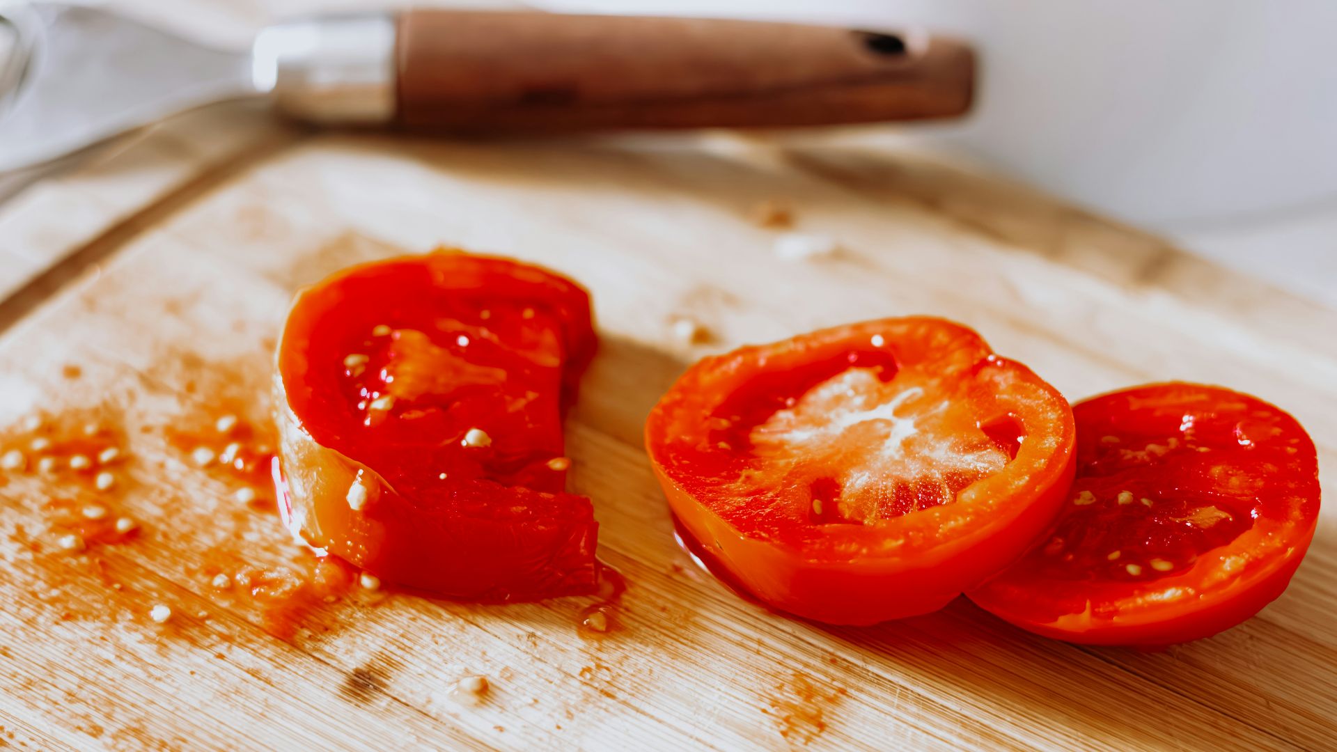 a wooden cutting board topped with sliced tomatoes
