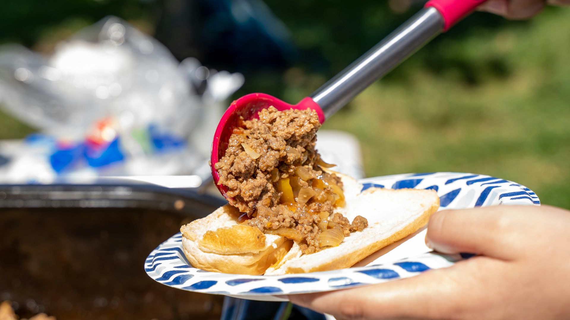 a person cutting a cake with a knife