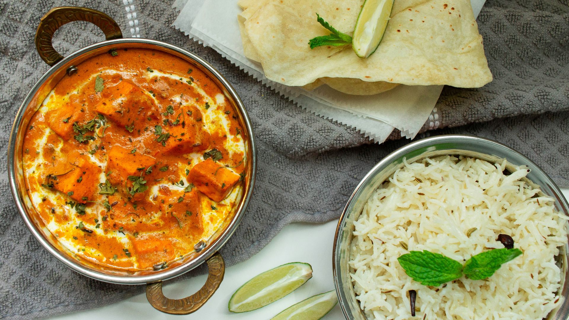 a table topped with bowls of food and a plate of nachos