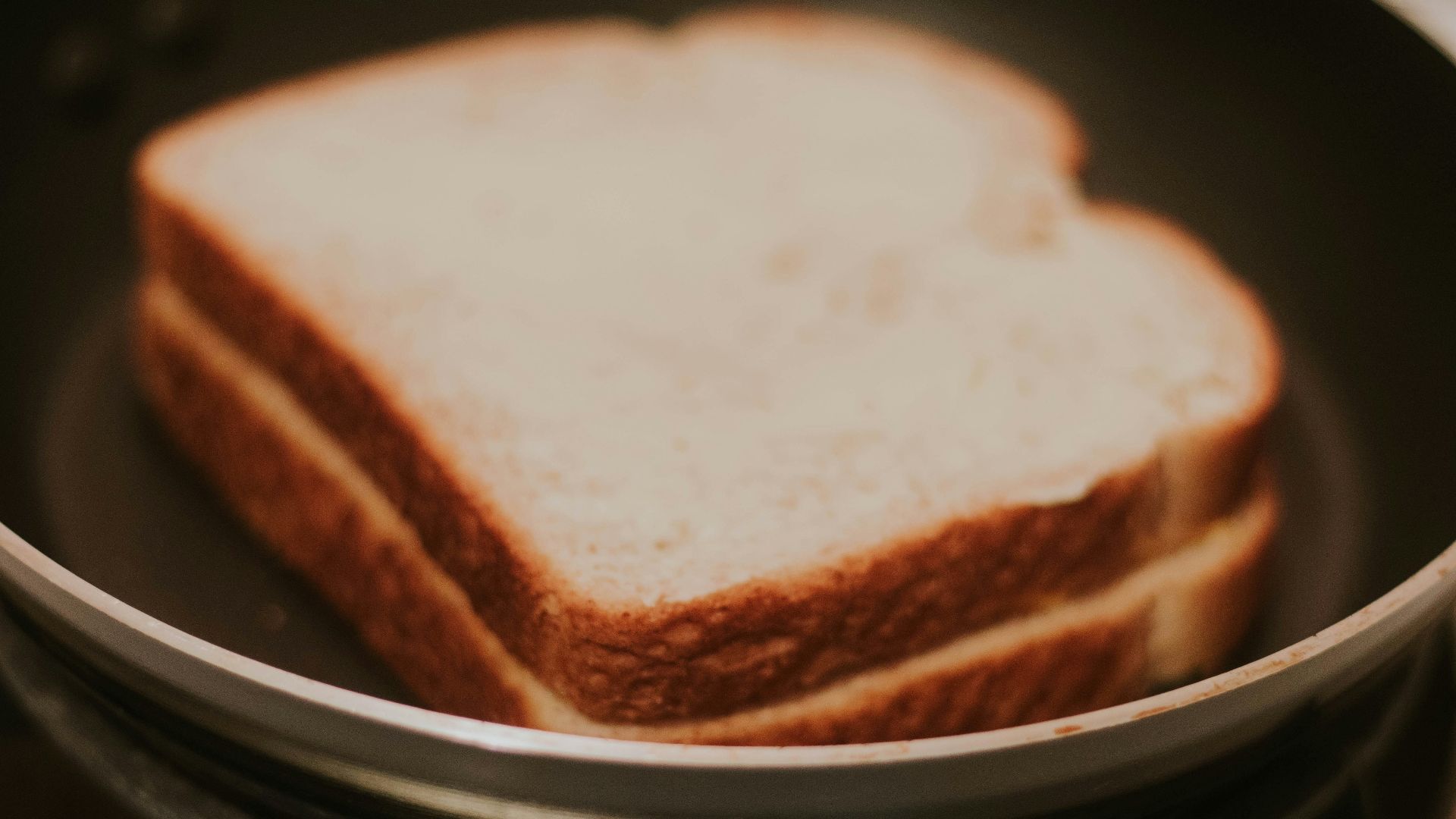 a close up of a sandwich in a pan on a stove