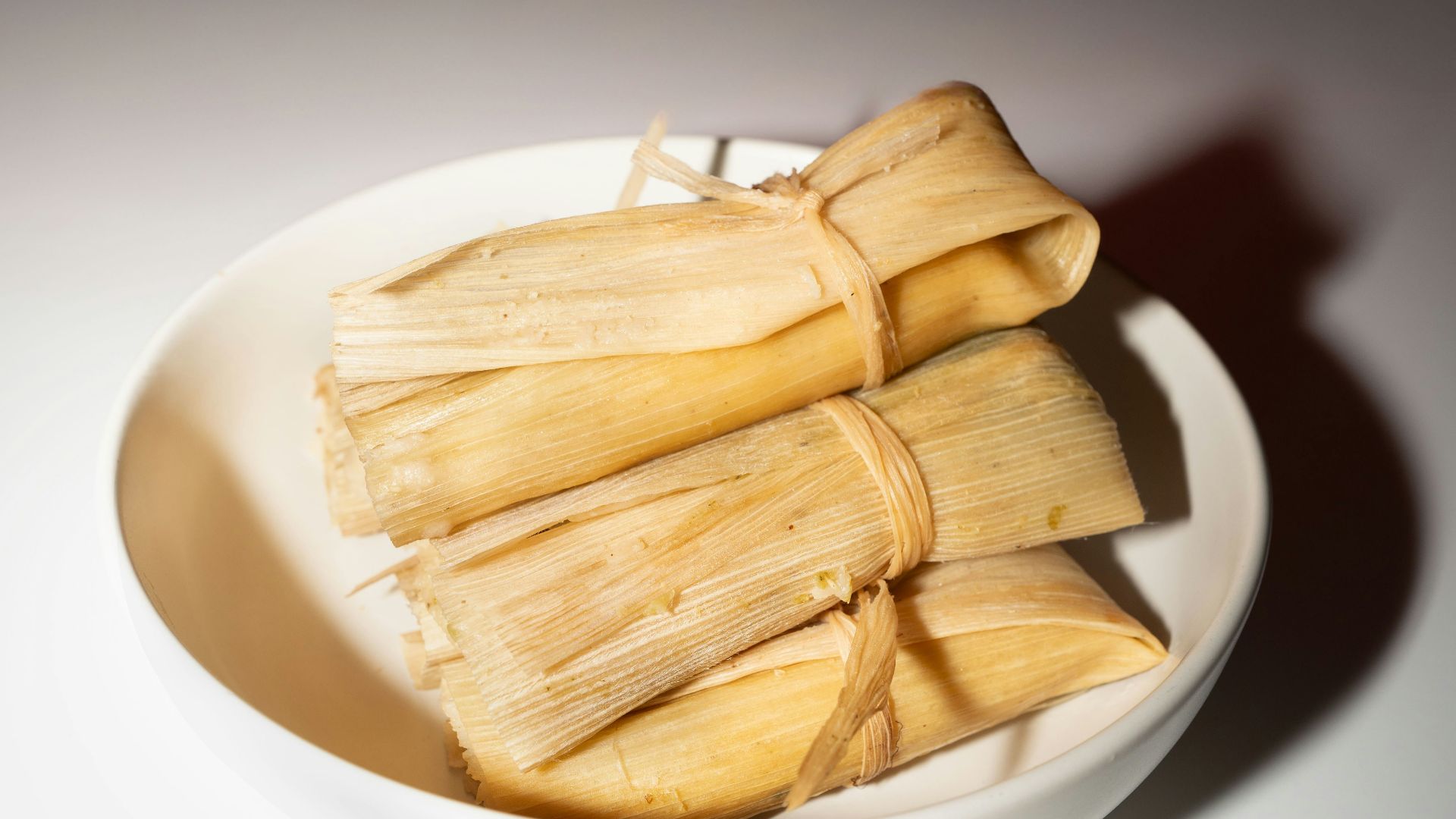 A white bowl filled with food on top of a table