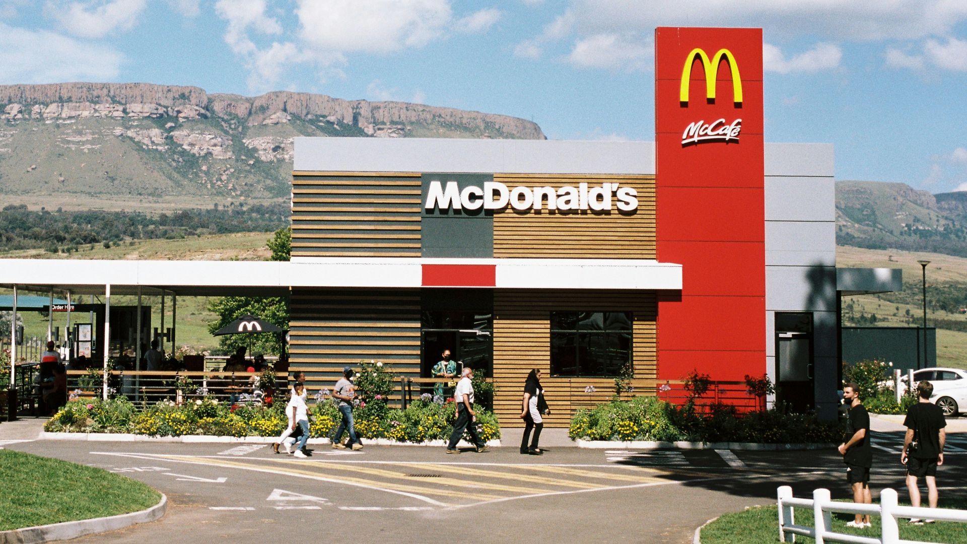 a mcdonald's restaurant with a mountain in the background
