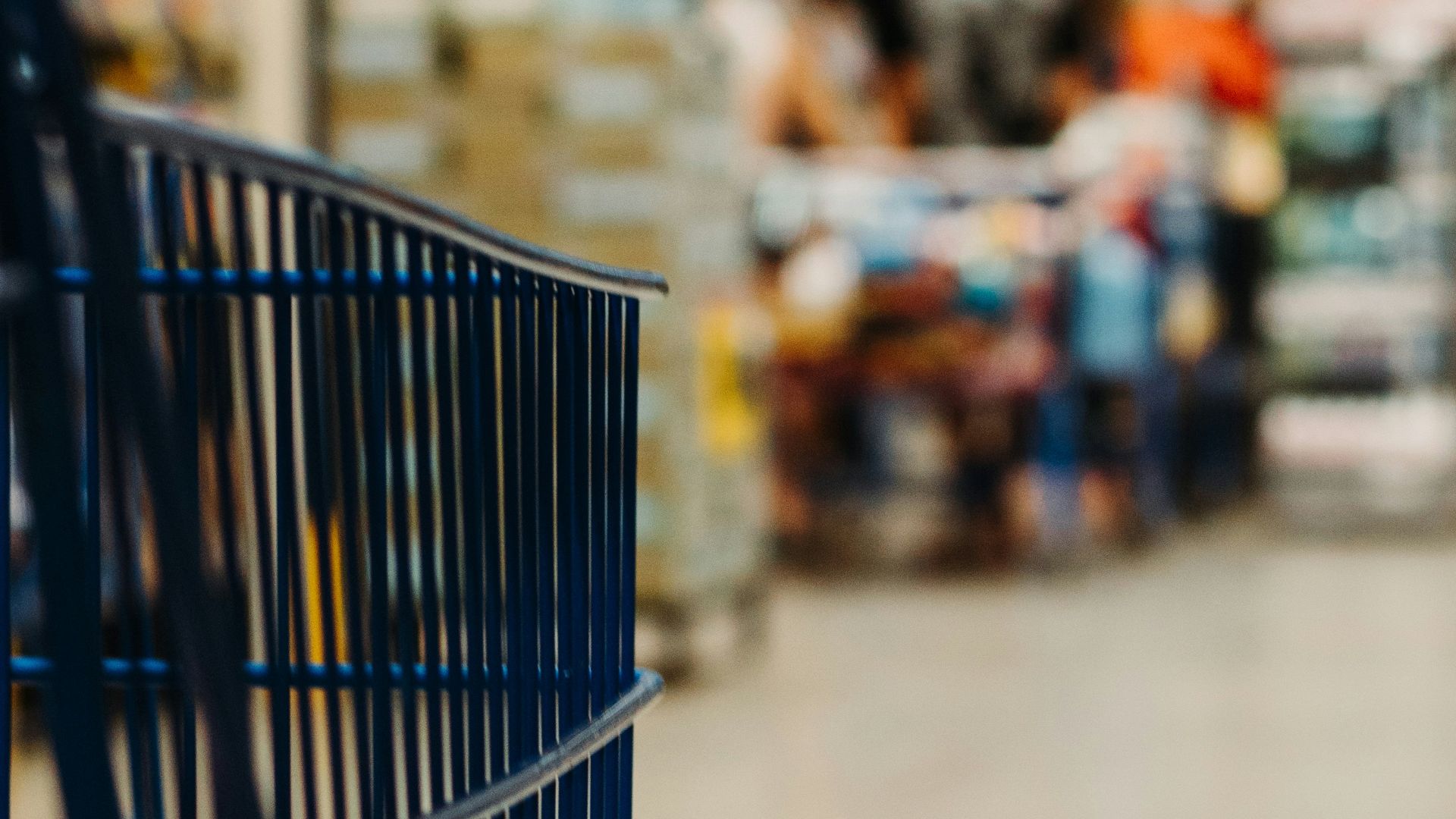 blue shopping cart on street during daytime