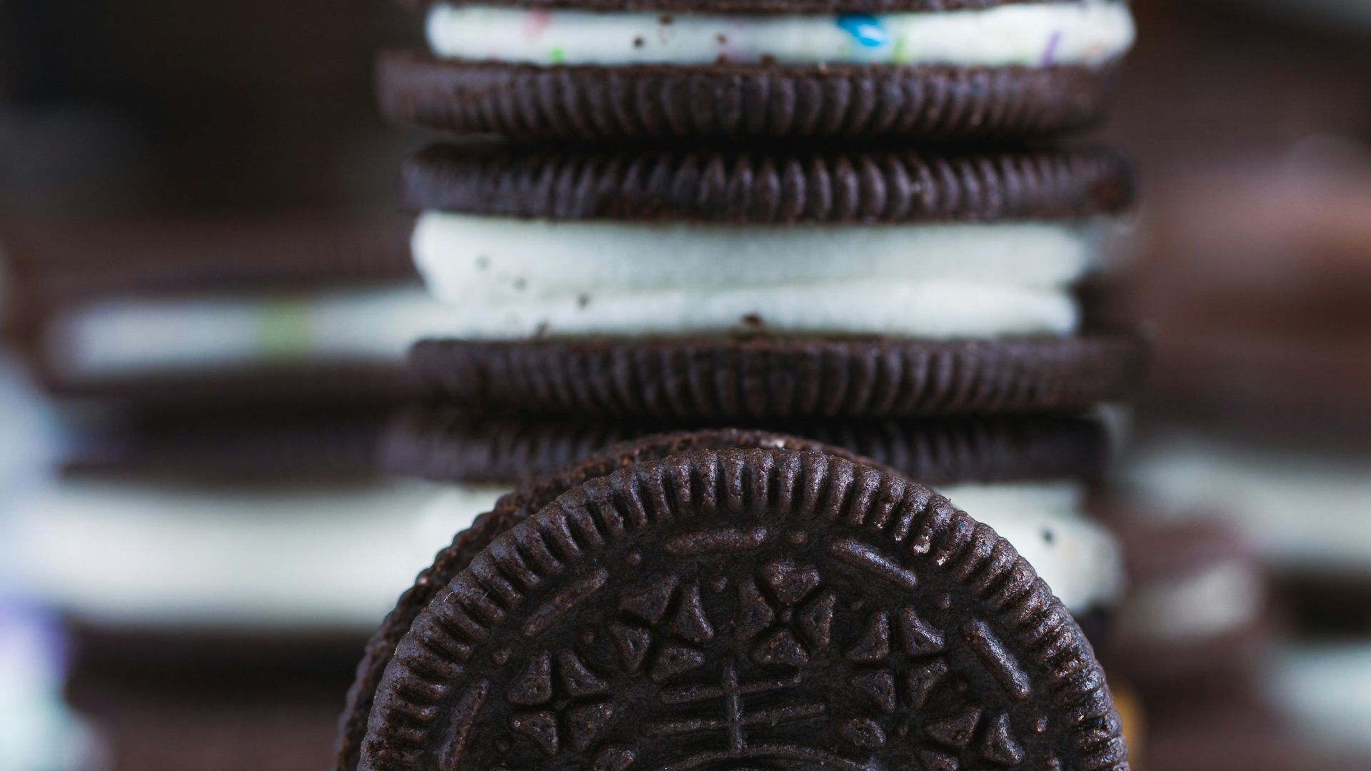 an oreo cookie sitting on top of a pile of cookies