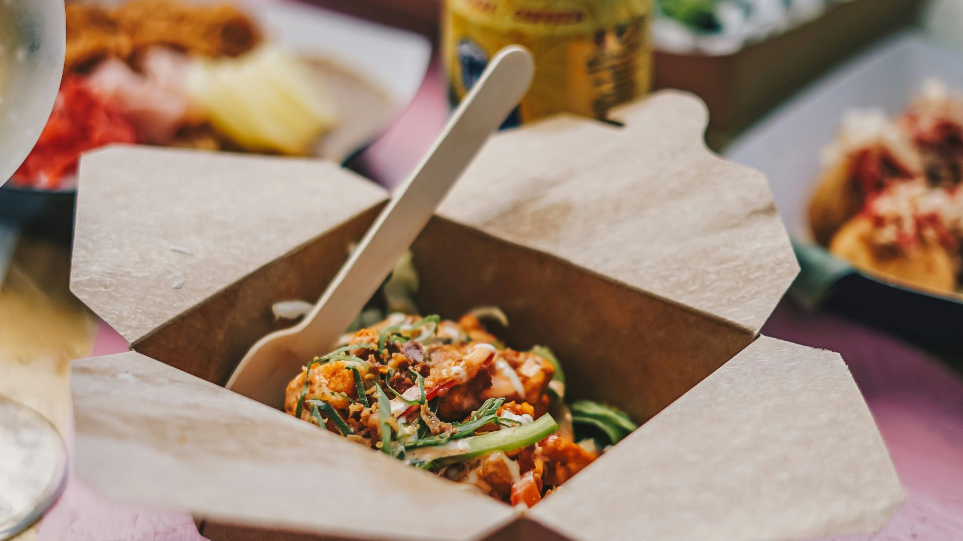 a table topped with boxes of food and drinks