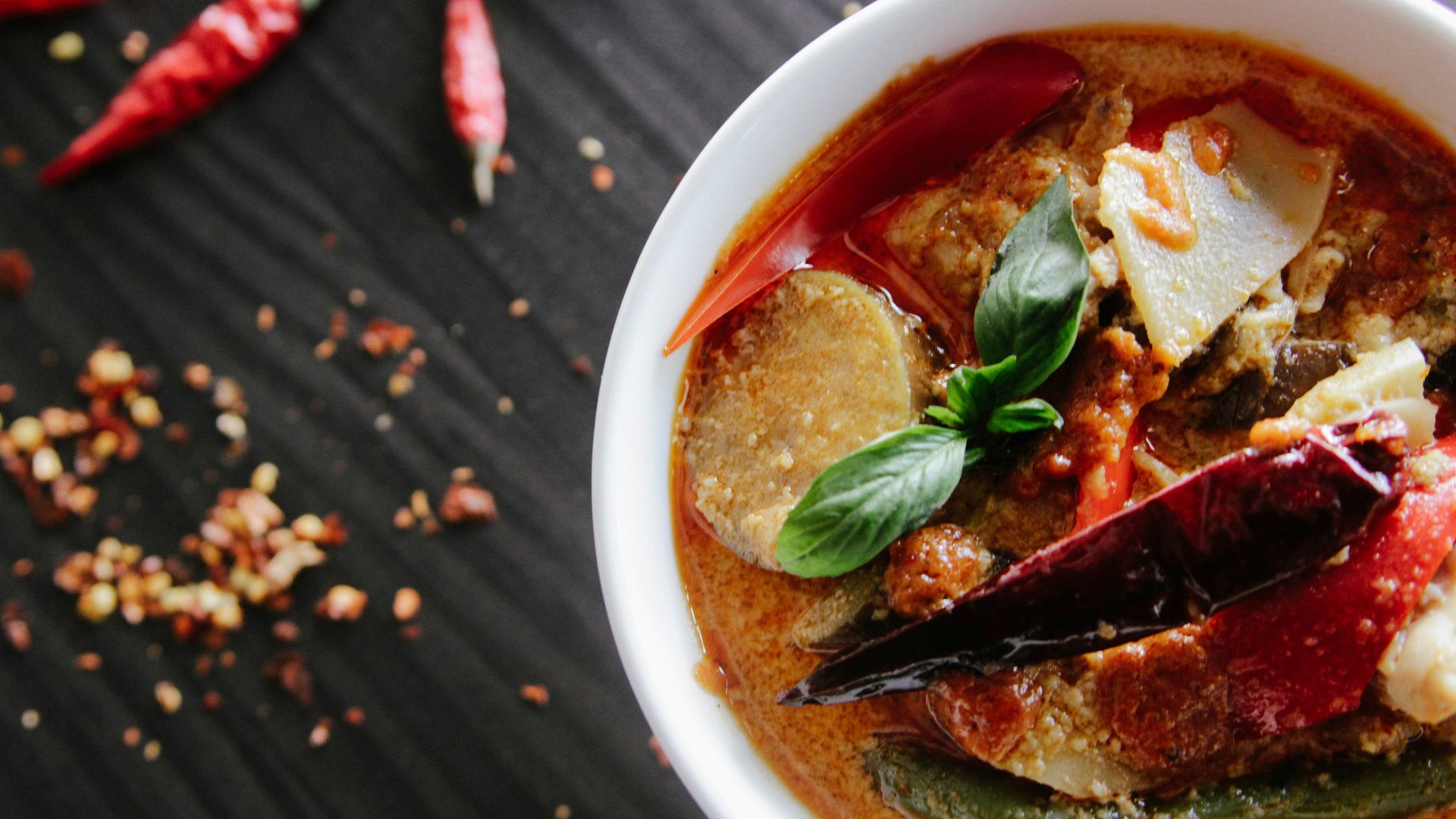 flat-lay photography of vegetable soup on white ceramic cup
