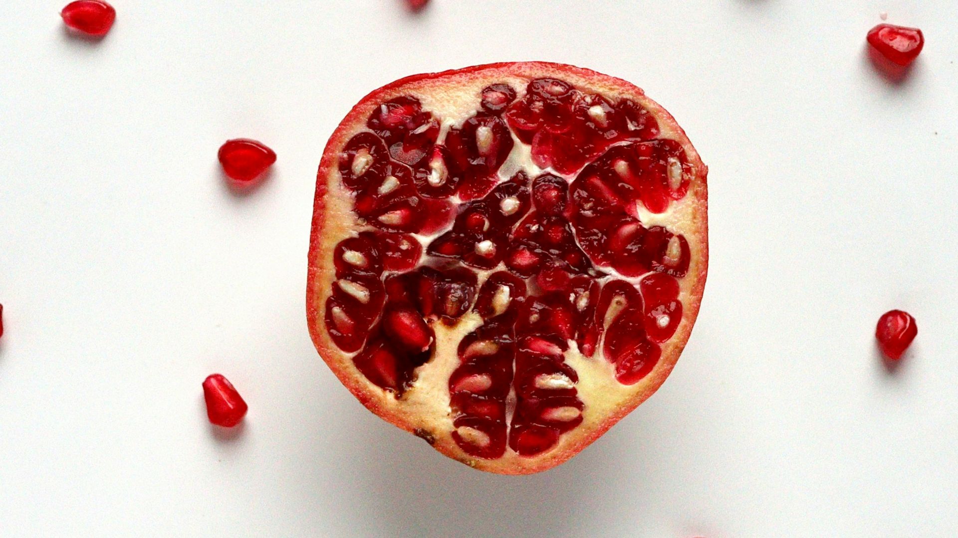 red sliced fruit on white surface