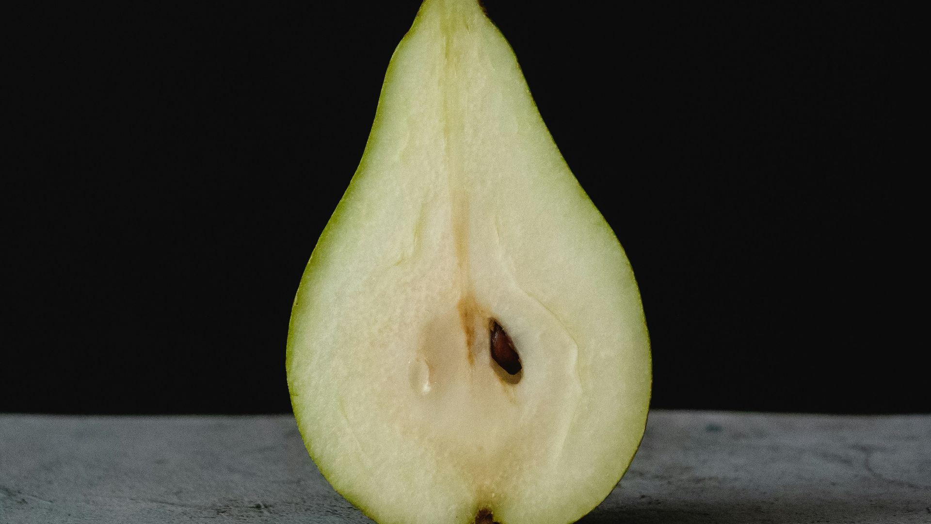 green fruit on gray wooden table