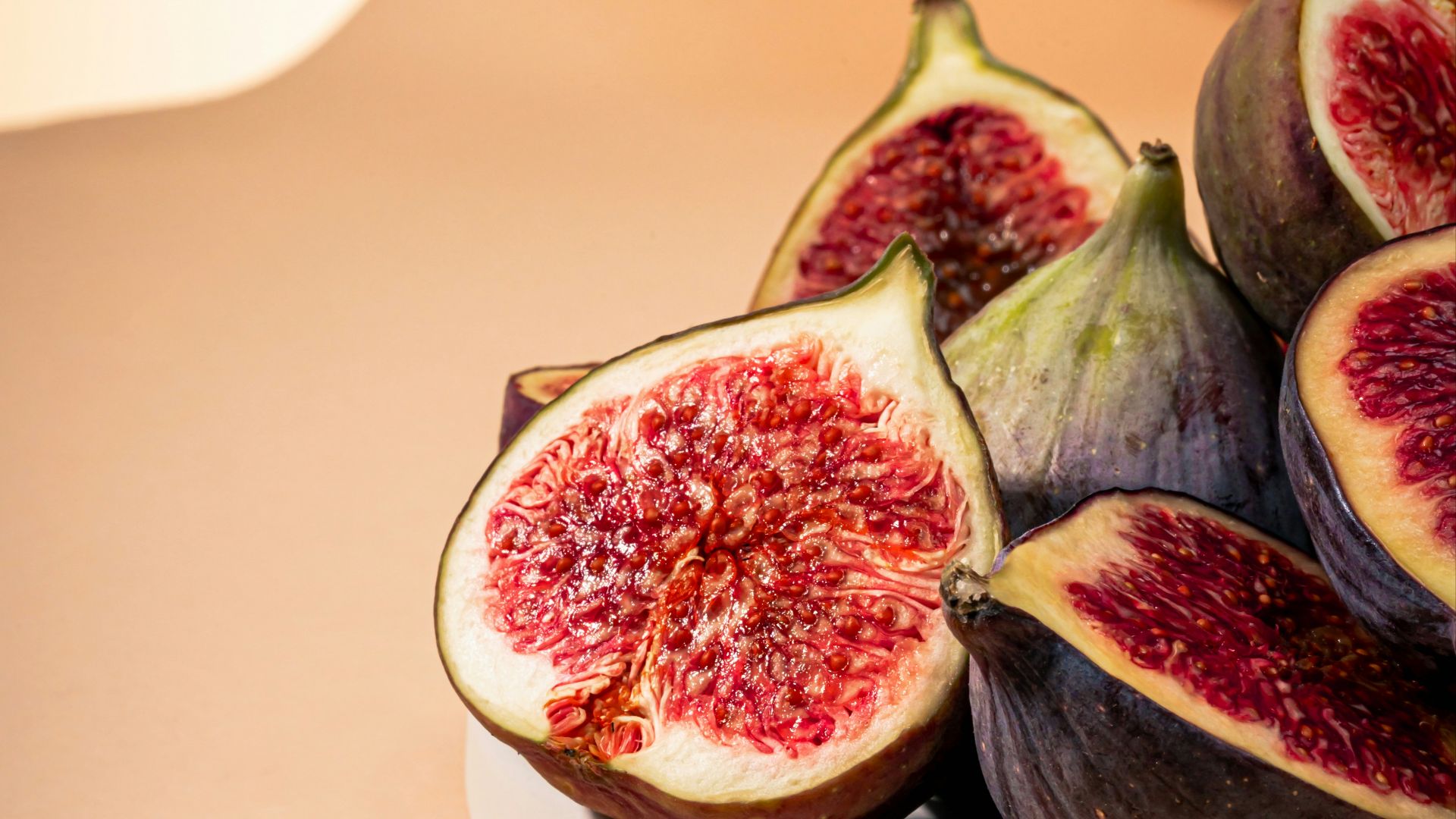 a white plate topped with sliced figs on top of a table