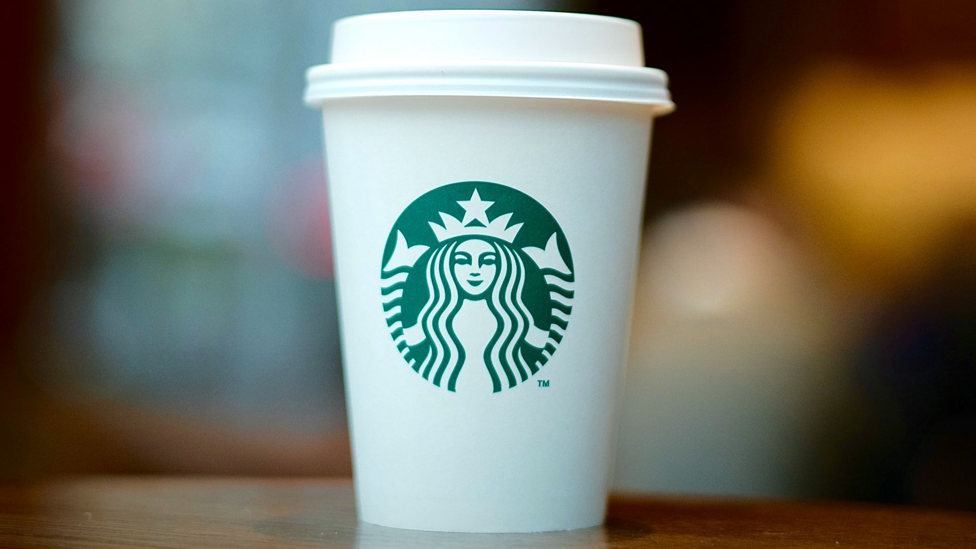 white and green starbucks disposable cup