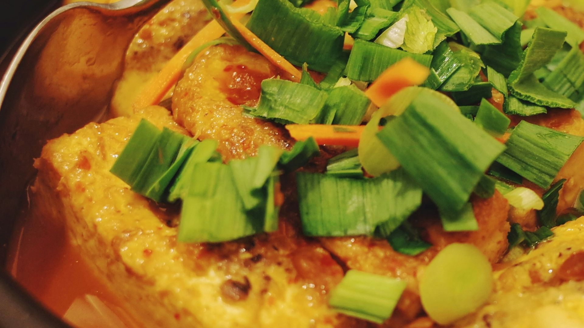 soup with vegetables in brown ceramic bowl