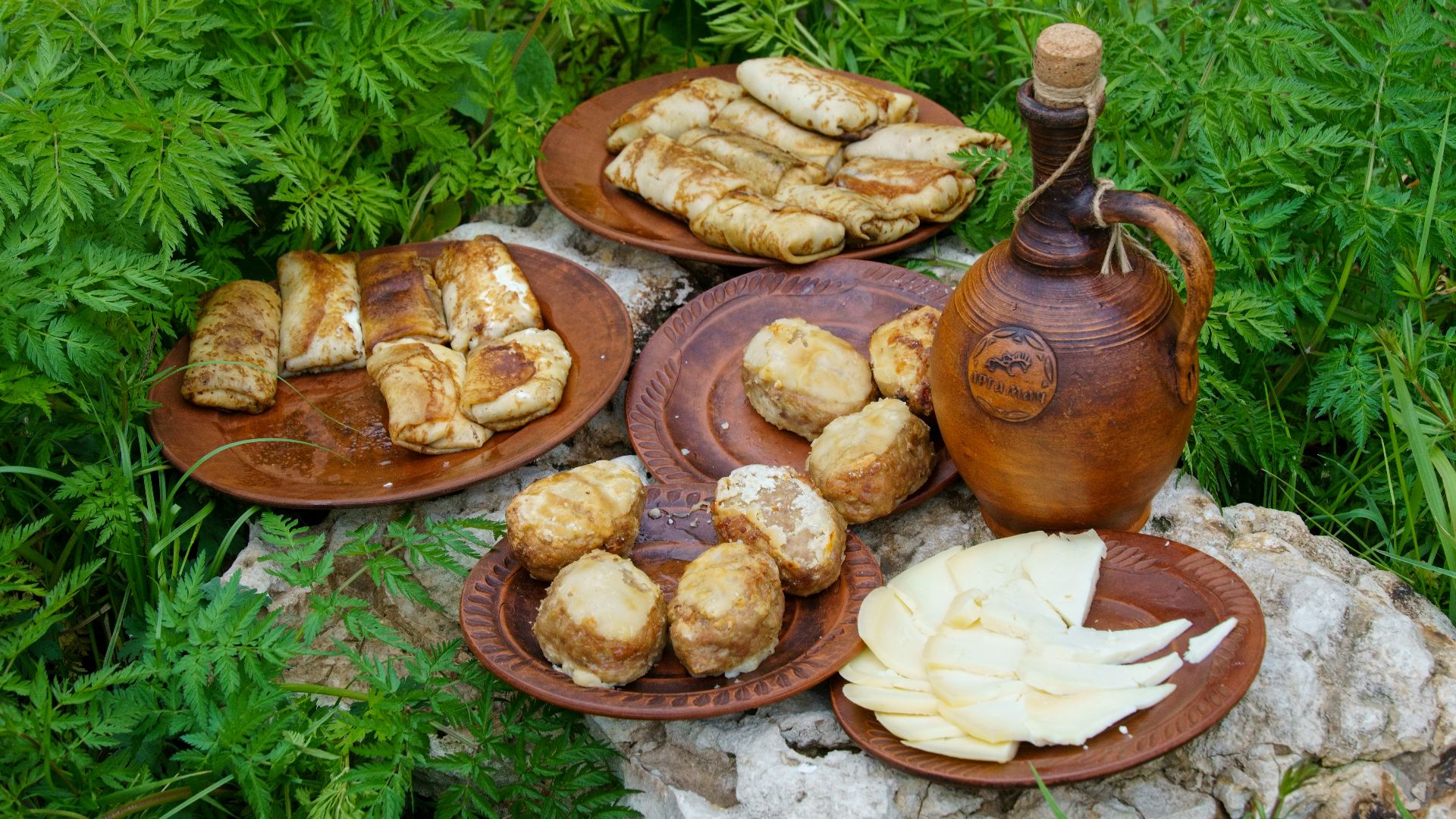 a table topped with plates of food and a tea pot