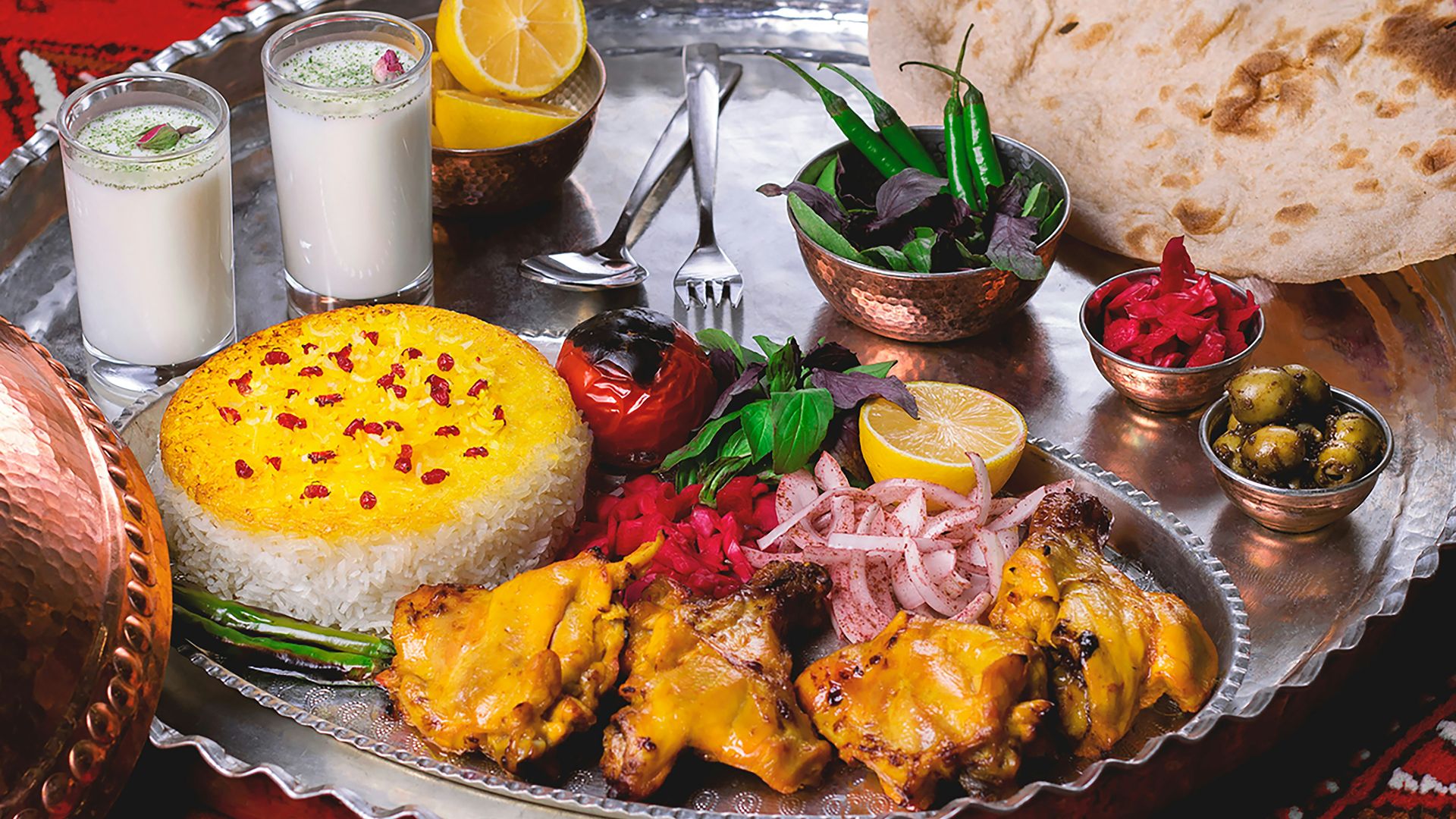 a silver plate topped with meat and vegetables