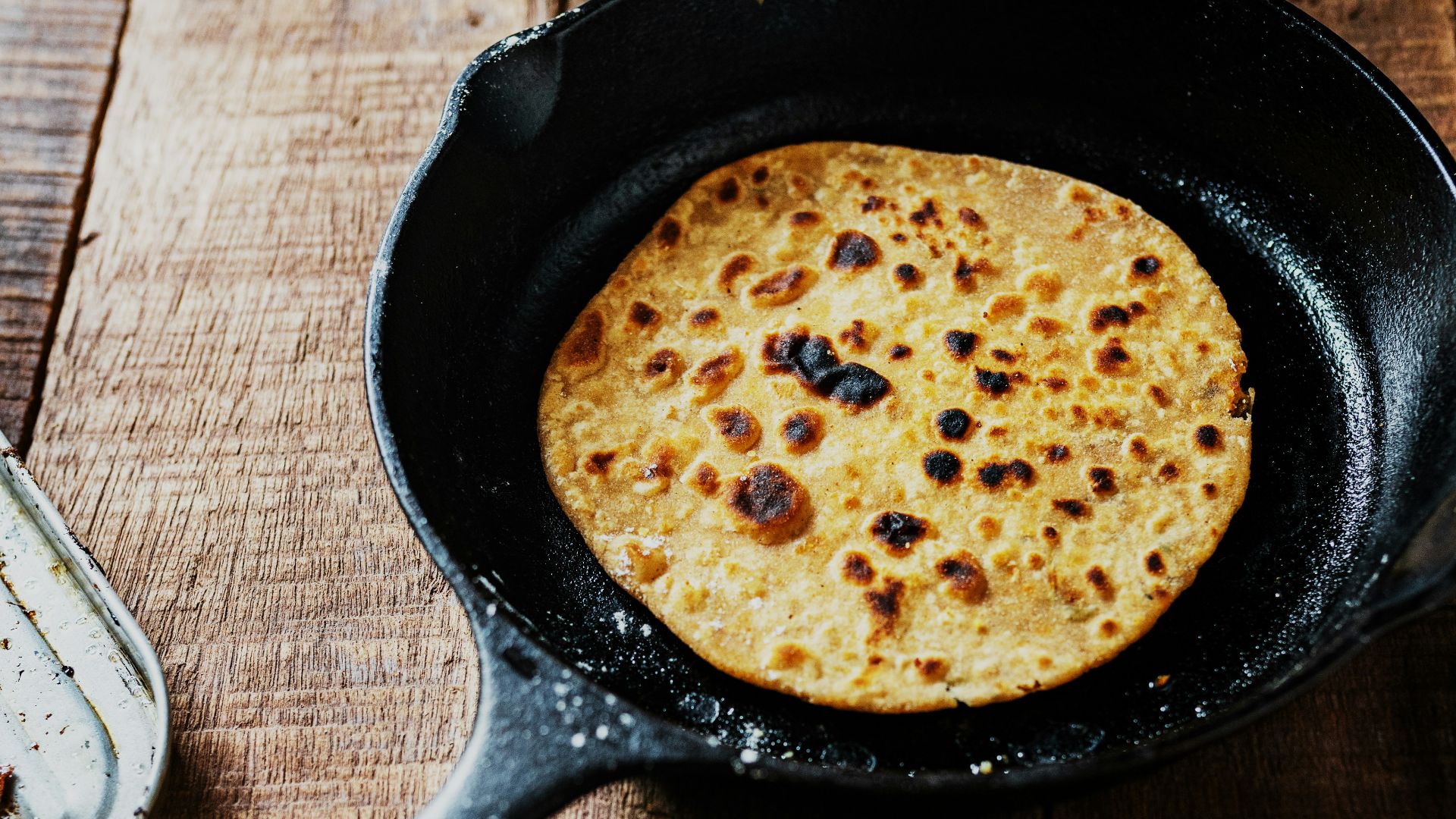 black frying pan on brown wooden table