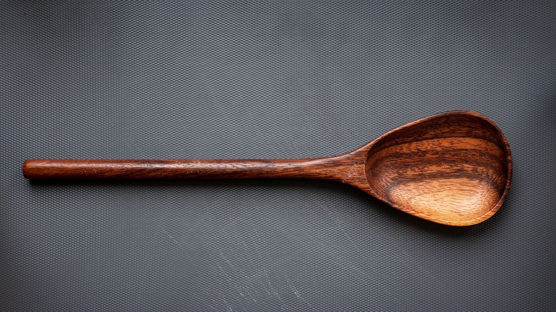 brown wooden spoon on white surface