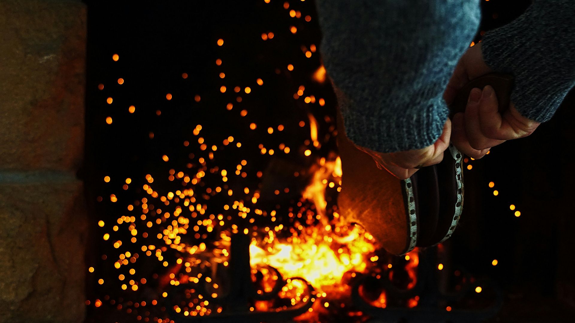 person in blue denim jacket holding fire