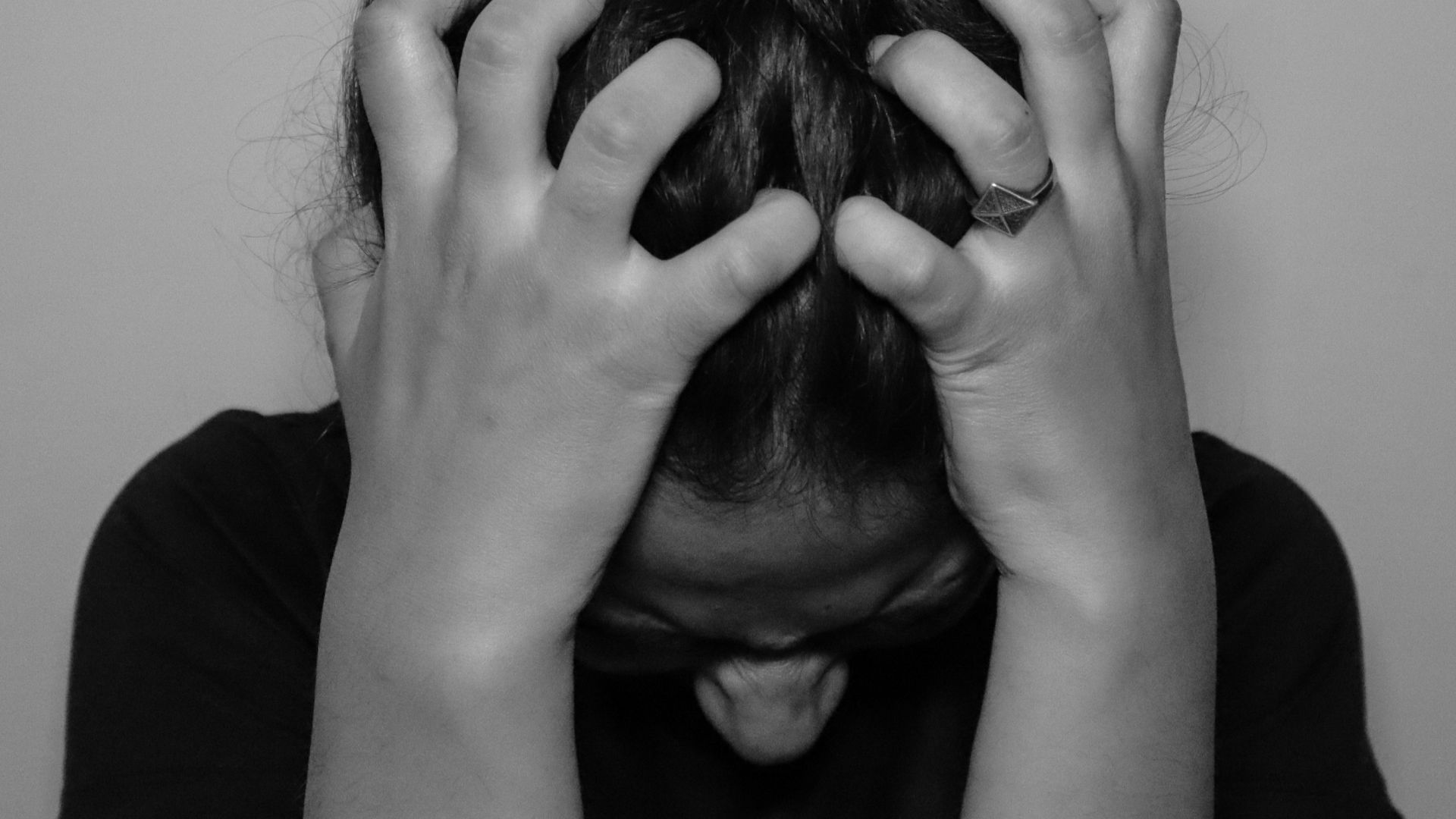 a woman covering her face with her hands