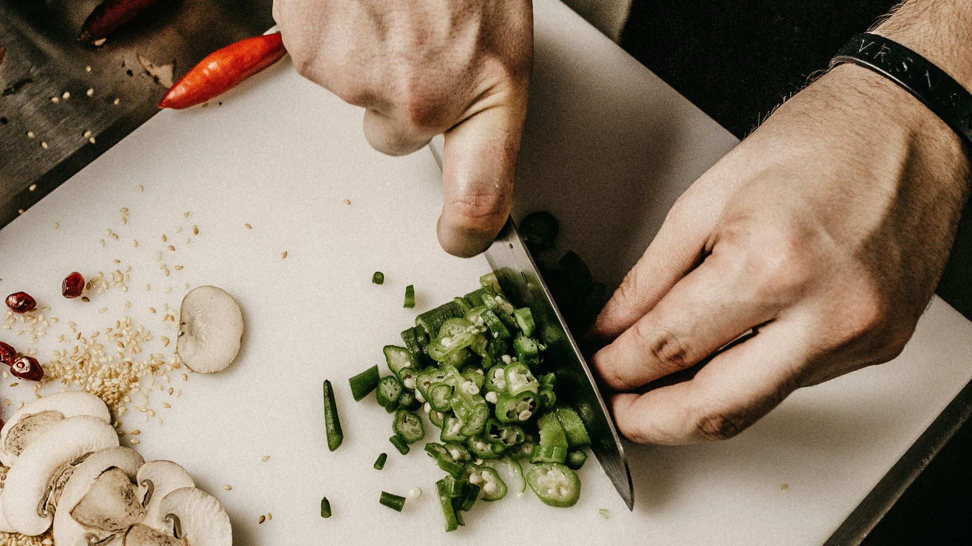 person slicing vegetable