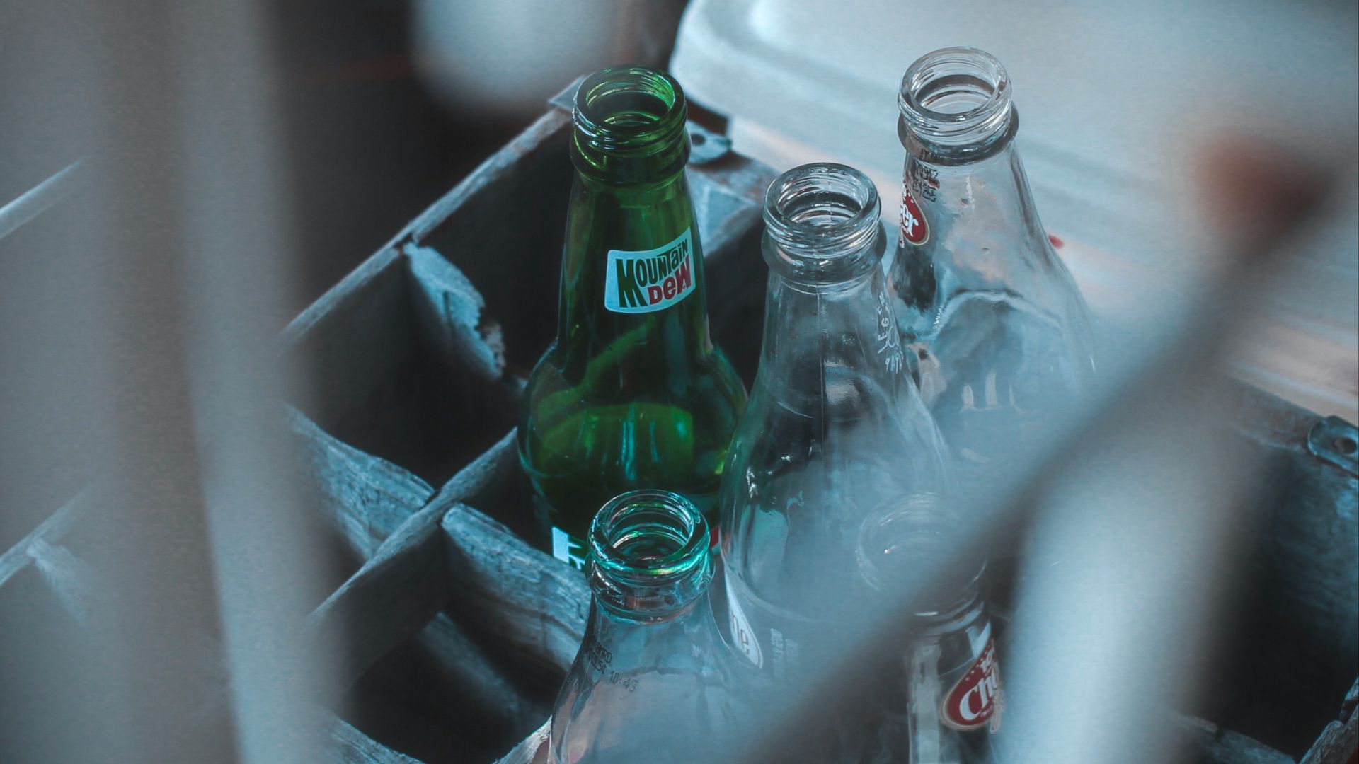 photo of glass soda bottles on crate